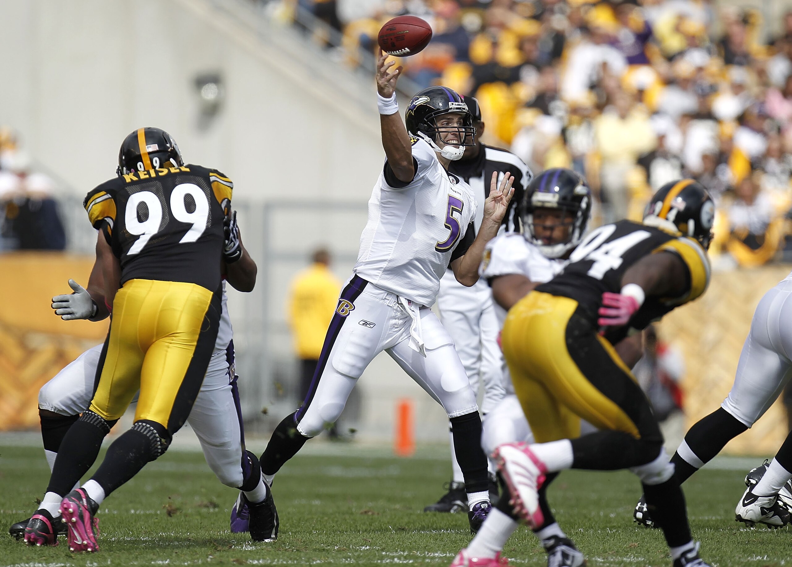 PITTSBURGH - OCTOBER 03:  Joe Flacco #5 of the Baltimore Ravens throws a pass between Brett Keisel #99 and Lawrence Timmons #94 of the Pittsburgh Steelers on October 3, 2010 at Heinz Field in Pittsburgh, Pennsylvania. Baltimore won the game 17-14.  (Photo