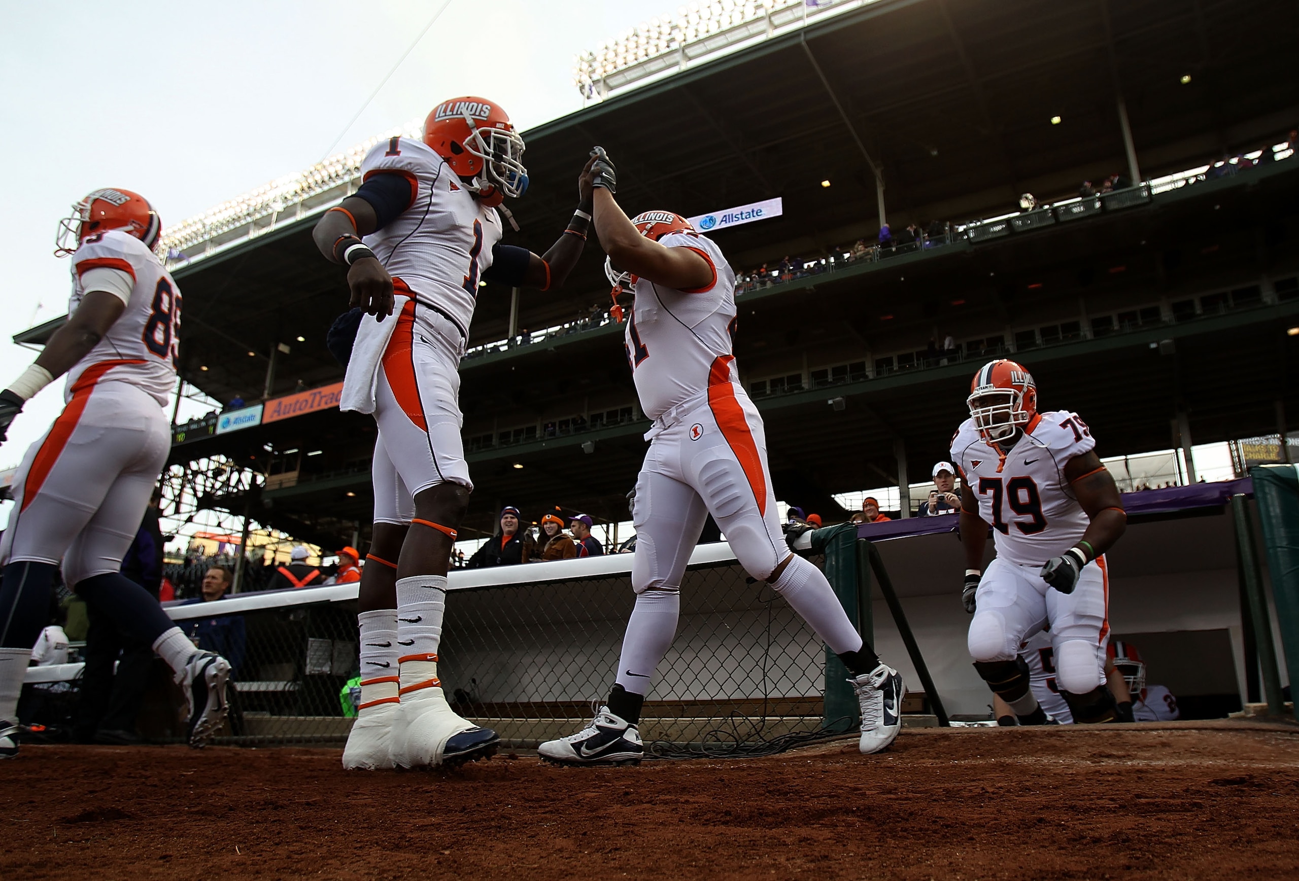 CHICAGO - NOVEMBER 20: Members of the Illinois Fighting Illini enter the field for warm-ups before a game against the Northwestern Wildcats played at Wrigley Field on November 20, 2010 in Chicago, Illinois. (Photo by Jonathan Daniel/Getty Images)