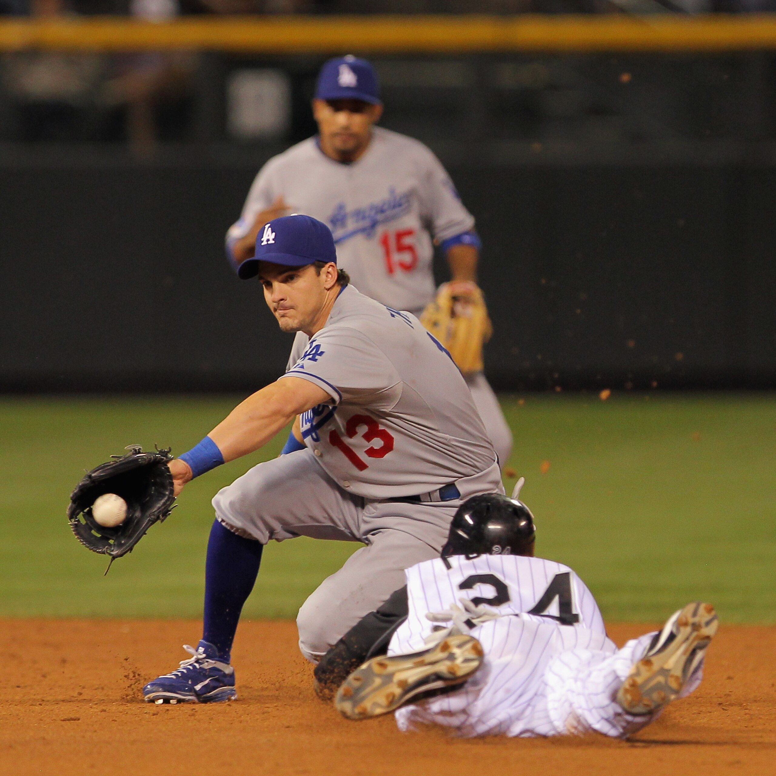 DENVER - SEPTEMBER 27:  Second baseman Ryan Theriot #13 of the Los Angeles Dodgers takes the throw as Dexter Fowler #24 of the Colorado Rockies steals second base at Coors Field on September 25, 2010 in Denver, Colorado.  (Photo by Doug Pensinger/Getty Im