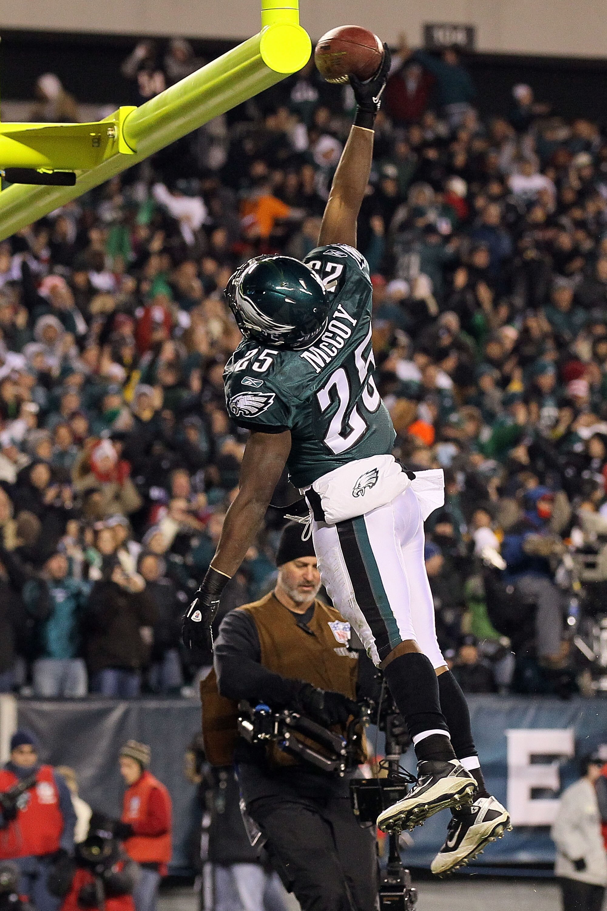 PHILADELPHIA, PA - DECEMBER 02:  Lesean Mccoy #25 of the Philadelphia Eagles dunks the ball over the goal post in celebration of scoring a 4-yard rushing touchdown in the second quarter against the Houston Texans at Lincoln Financial Field on December 2, 