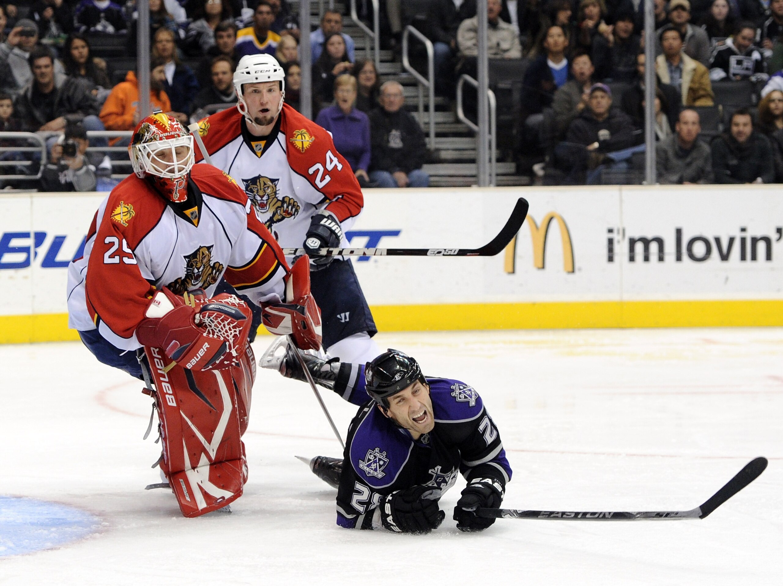 LOS ANGELES, CA - DECEMBER 02:  Jarret Stoll #28 of the Los Angeles Kings is upended by Tomas Vokoun #29 of the Florida Panthers as Bryan McCabe #24 looks on during the second period on December 2, 2010 in Los Angeles, California.  (Photo by Harry How/Get
