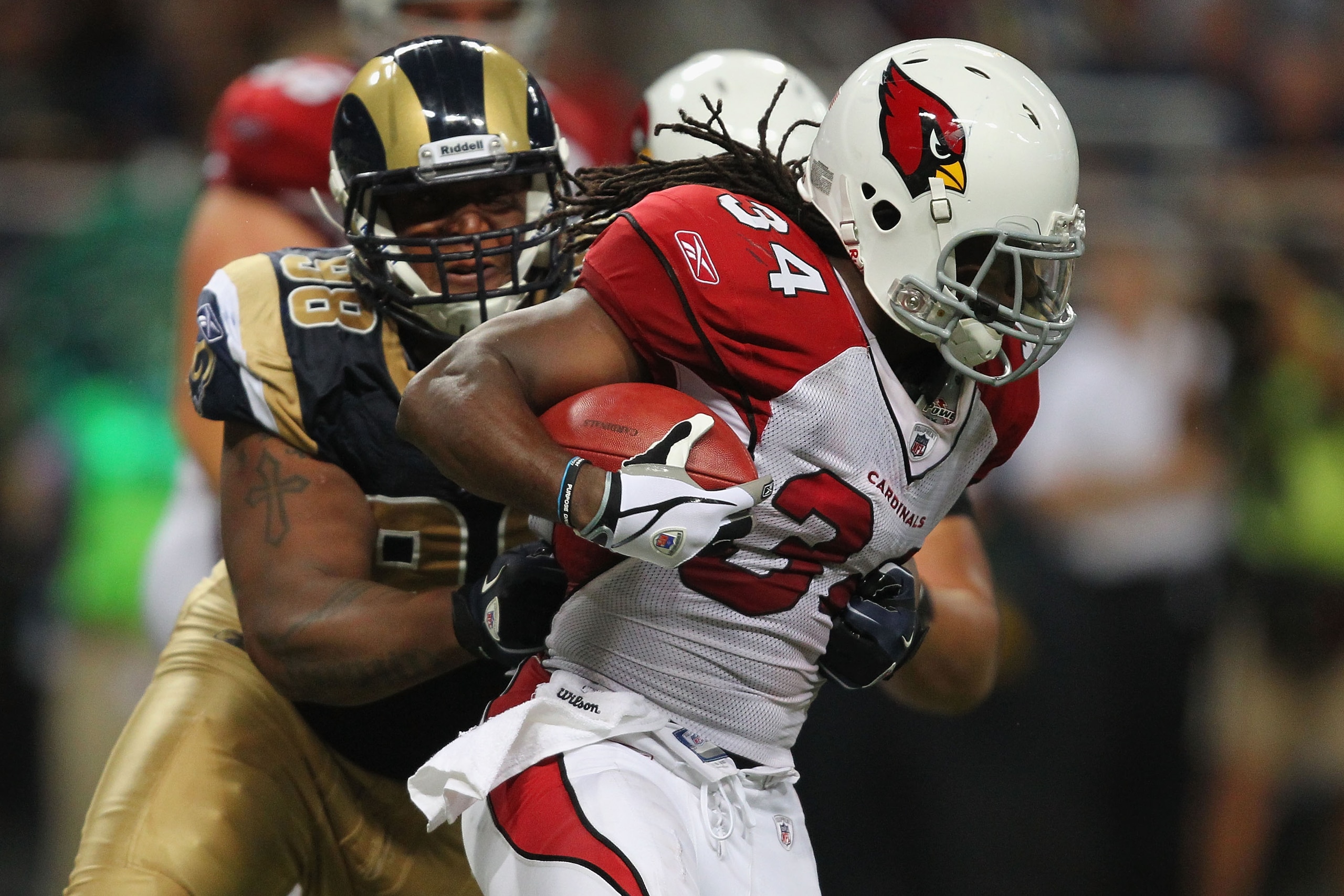 ST. LOUIS - SEPTEMBER 12: Tim Hightower #34 of the Arizona Cardinals is tackled by Fred Robbins #98 of the St. Louis Rams during the NFL season opener at the Edward Jones Dome on September 12, 2010 in St. Louis, Missouri.  The Cardinals beat the Rams 17-1