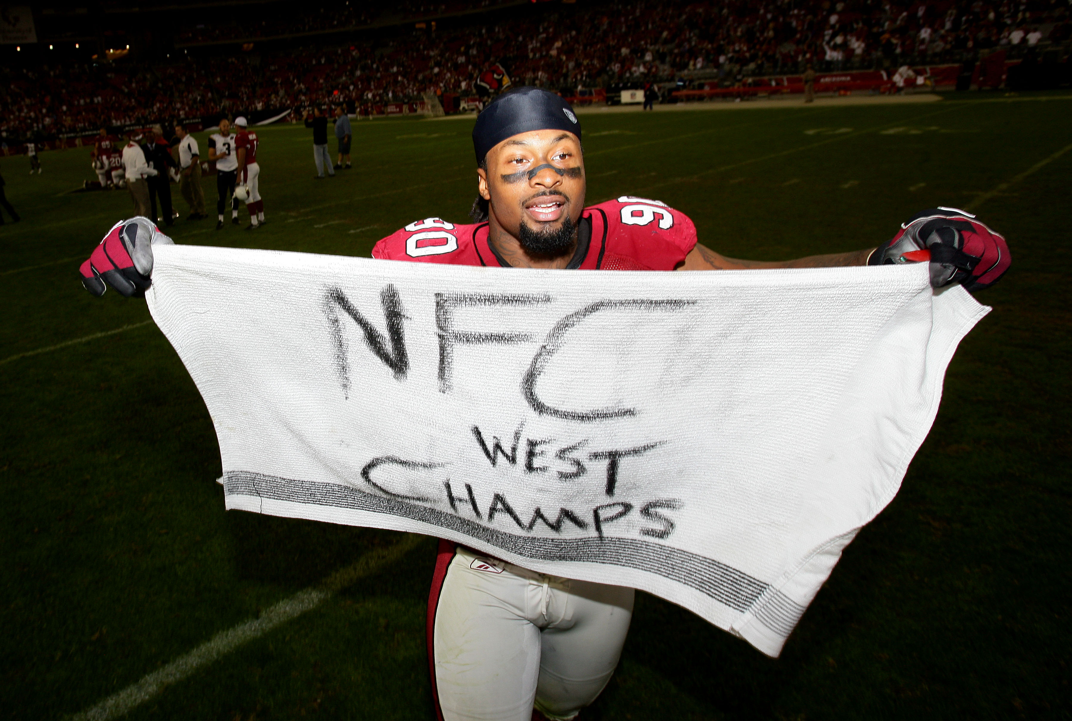 GLENDALE, AZ - DECEMBER 7:  Darnell Dockett #90 of the Arizona Cardinals celebrates his team's 34-10 win over the St. Louis Rams to clinch the NFC West Title during their NFL game on December 7, 2008 at the University of Phoenix Stadium in Glendale, Arizo