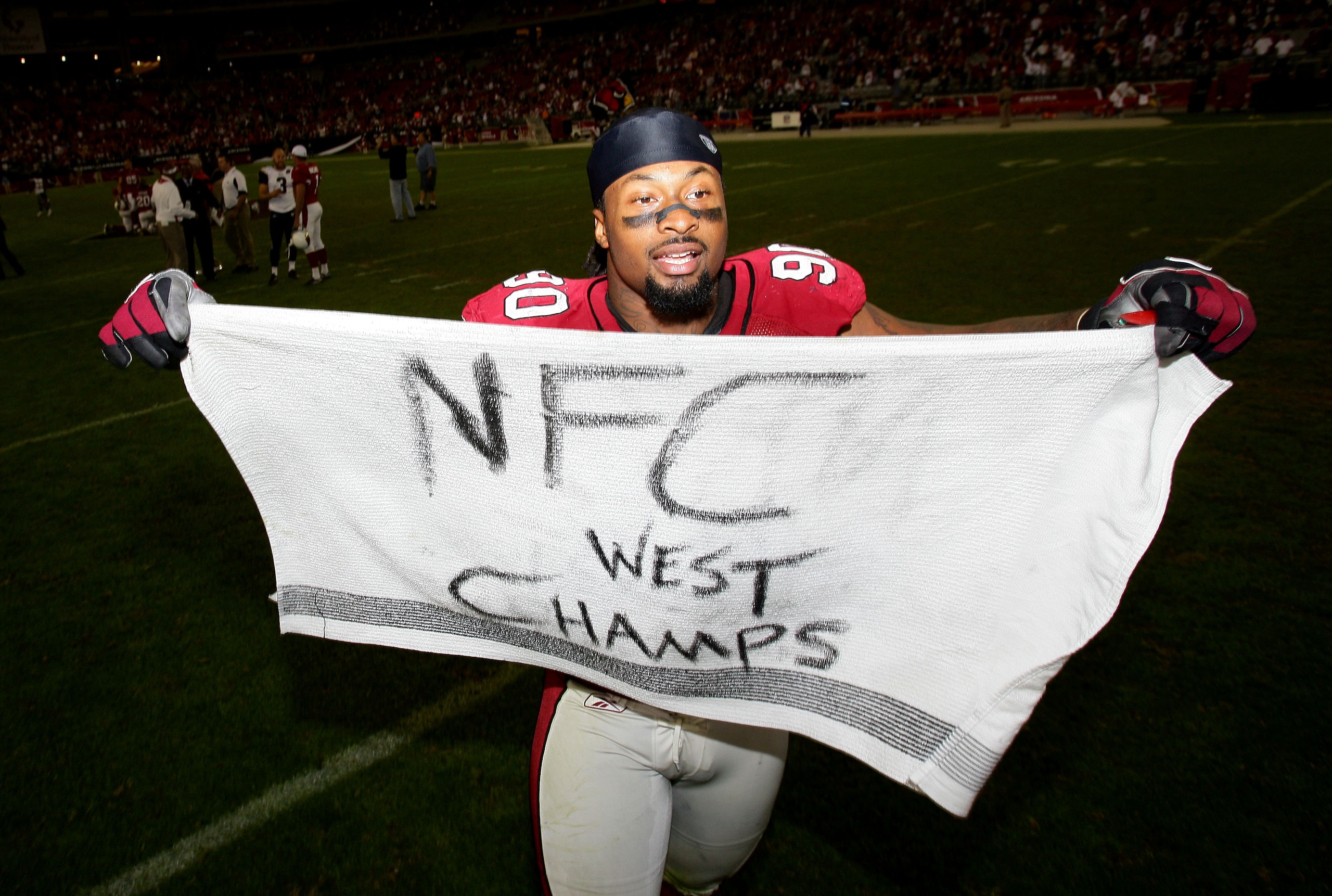 GLENDALE, AZ - DECEMBER 7:  Darnell Dockett #90 of the Arizona Cardinals celebrates his team's 34-10 win over the St. Louis Rams to clinch the NFC West Title during their NFL game on December 7, 2008 at the University of Phoenix Stadium in Glendale, Arizo