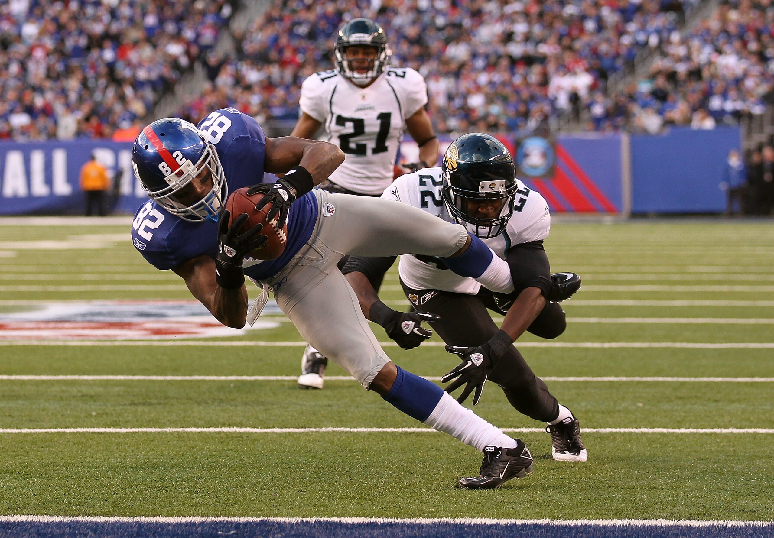 EAST RUTHERFORD, NJ - NOVEMBER 28:  Mario Manningham #82 of the New York Giants scores a touchdown in the fourth Quarter as Don Carey #22 of the Jacksonville Jaguars misses the tackle during their game on November 28, 2010 at The New Meadowlands Stadium i