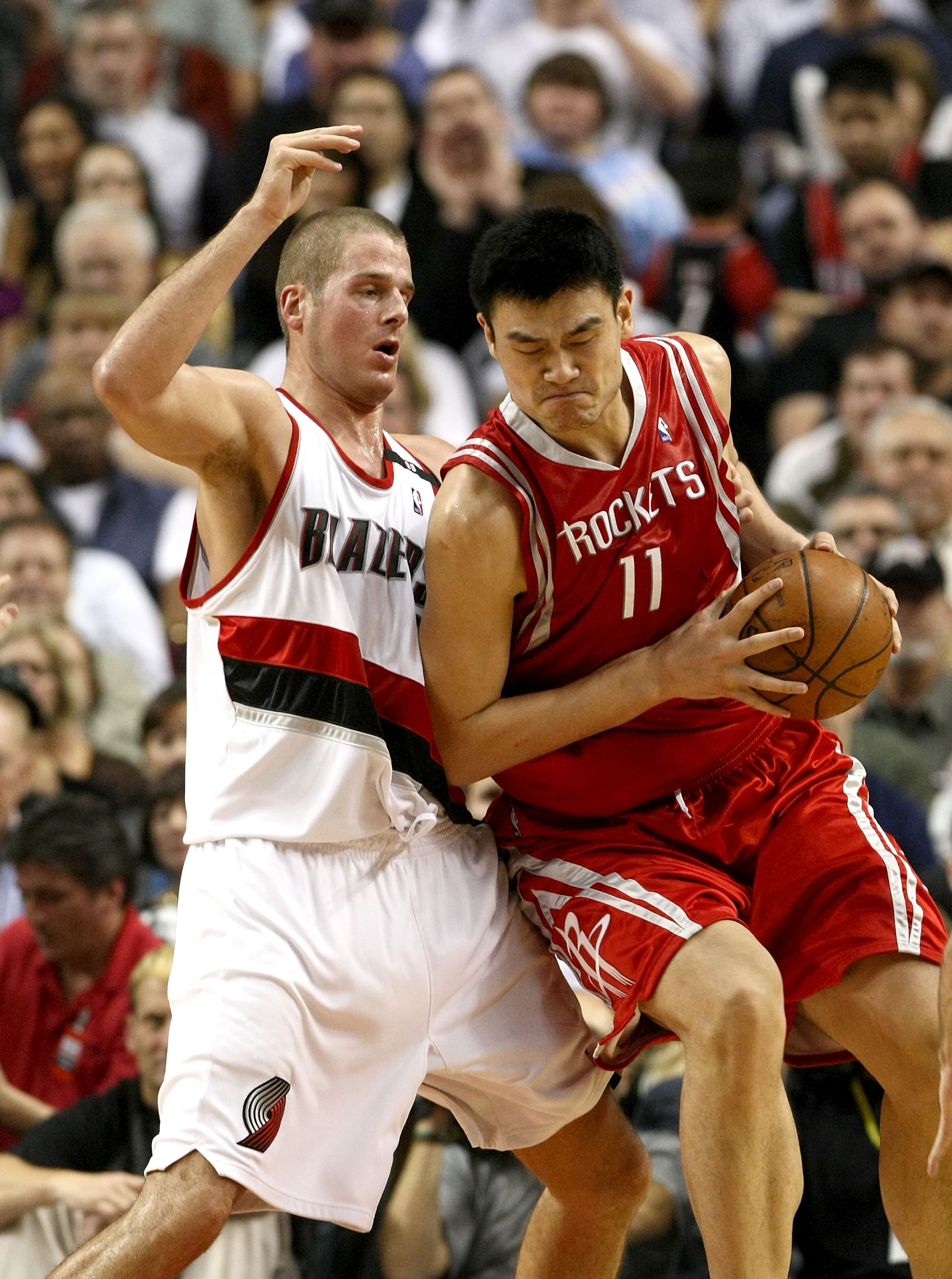 PORTLAND, OR - NOVEMBER 06: Yao Ming #11 of the Houston Rockets is defended by Joel Przybilla #10 of the Portland Trail Blazers at the Rose Garden on November 6, 2008 in Portland, Oregon.  NOTE TO USER: User expressly acknowledges and agrees that, by down