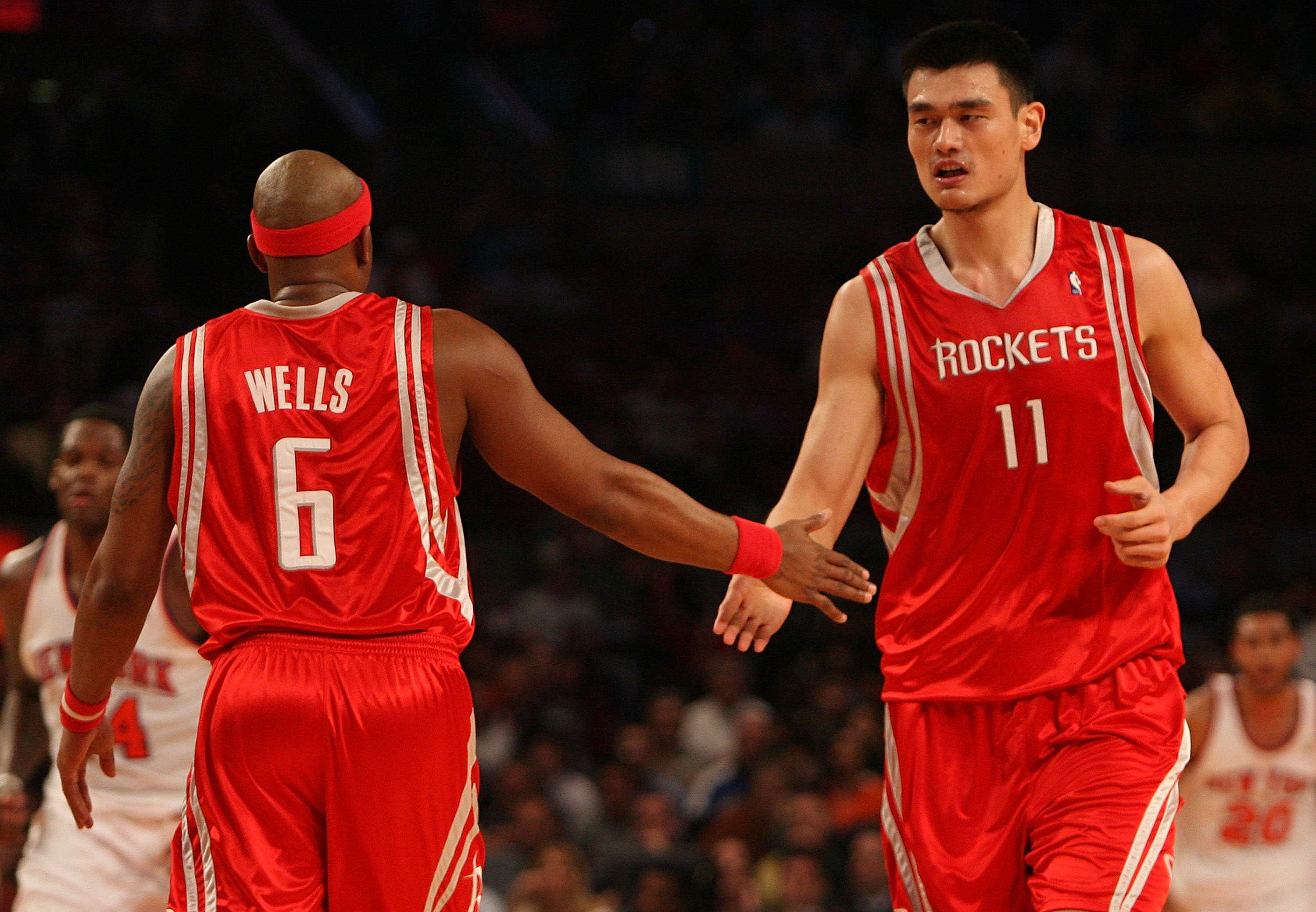 NEW YORK - JANUARY 09:  Yao Ming #11 of the Houston Rockets celebrates a basket with teammate Bonzi Wells #6 against the New York Knicks on January 9, 2008 at Madison Square Garden in New York City. NOTE TO USER: User expressly acknowledges and agrees tha