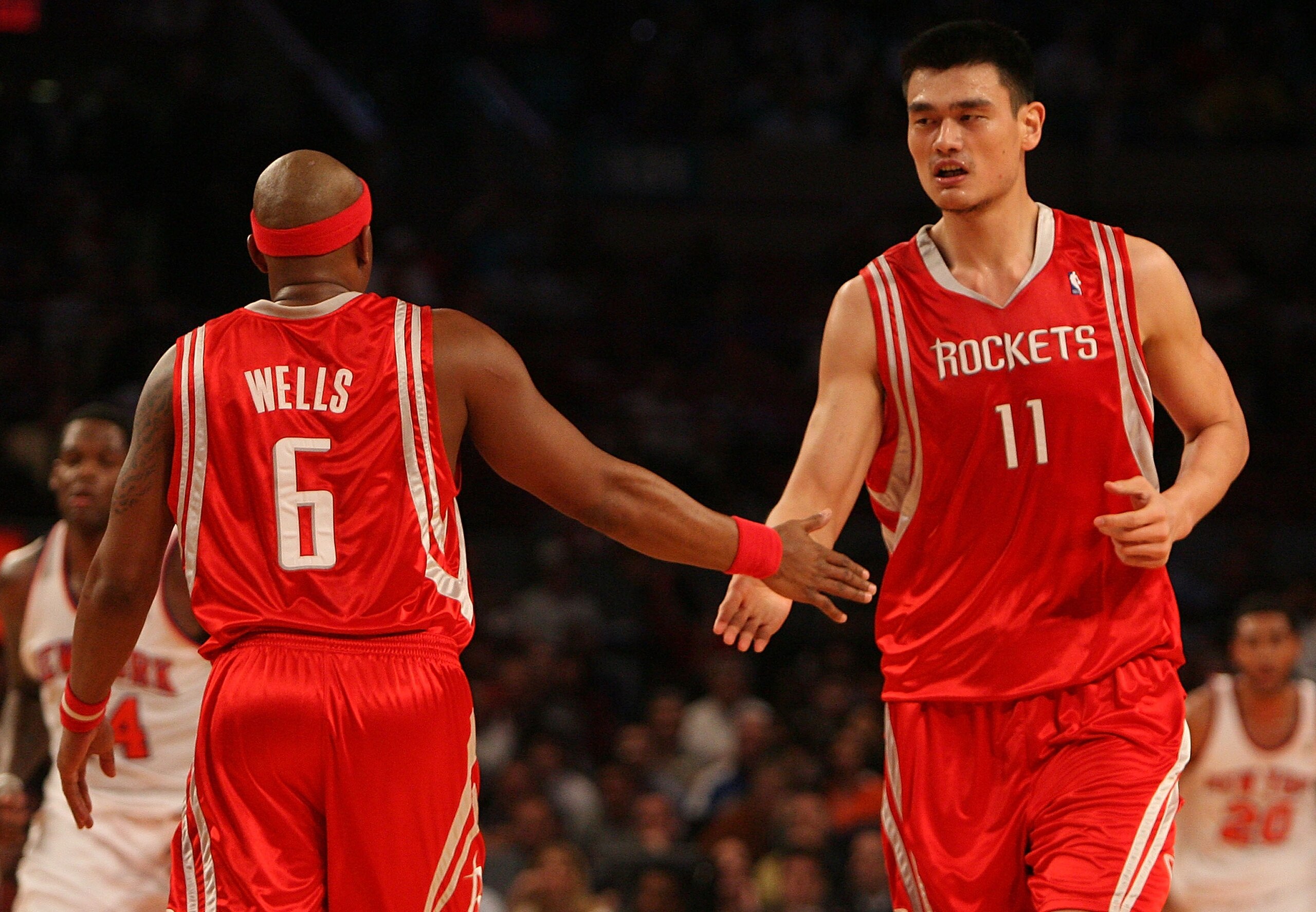 NEW YORK - JANUARY 09:  Yao Ming #11 of the Houston Rockets celebrates a basket with teammate Bonzi Wells #6 against the New York Knicks on January 9, 2008 at Madison Square Garden in New York City. NOTE TO USER: User expressly acknowledges and agrees tha