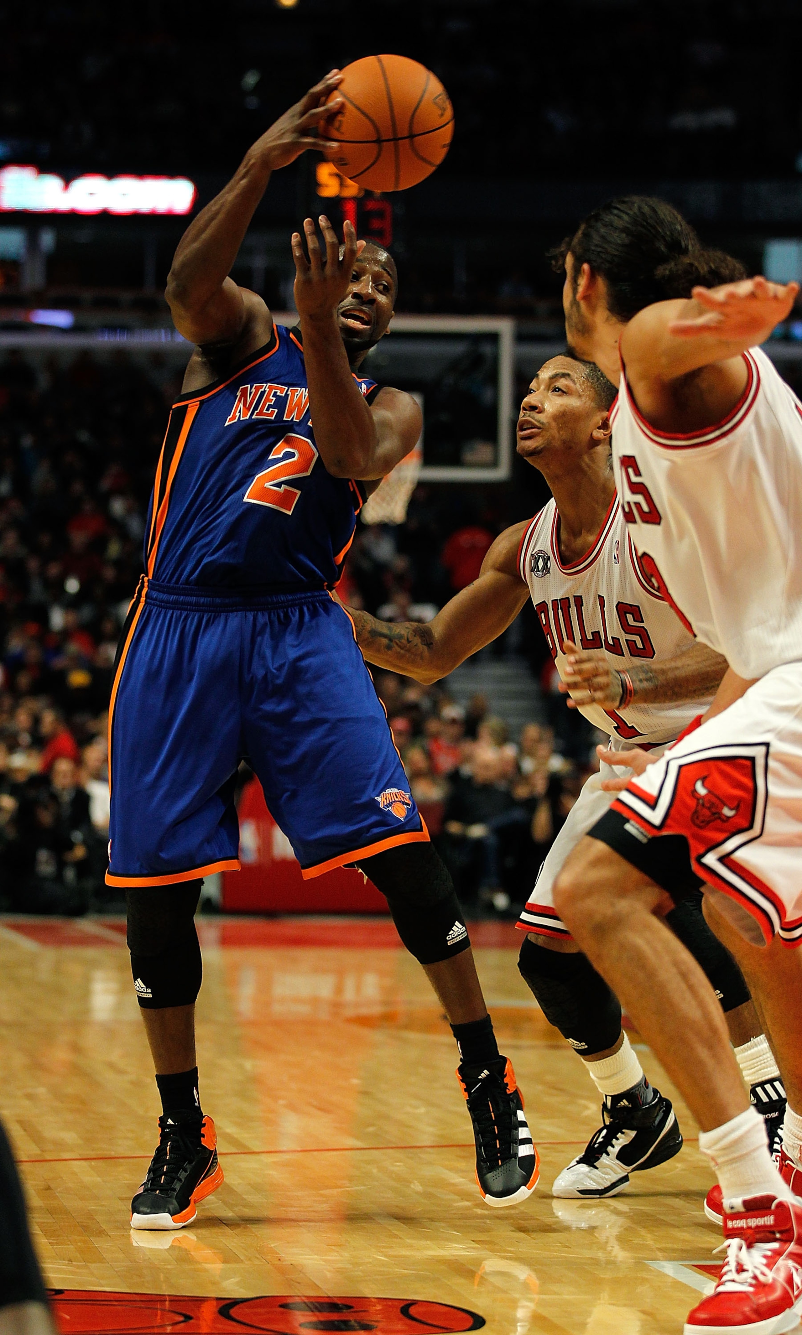 CHICAGO - NOVEMBER 04: Raymond Felton #2 of the New York Knicks passes the ball over Derrick Rose #1 and Joakim Noah #13 of the Chicago Bulls at the United Center on November 4, 2010 in Chicago, Illinois. NOTE TO USER: User expressly acknowledges and agre