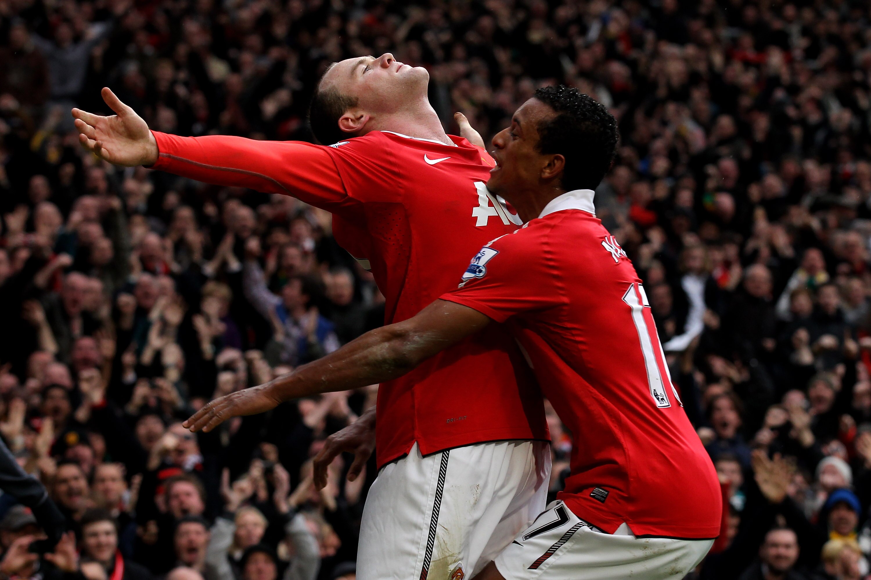 MANCHESTER, ENGLAND - FEBRUARY 12:  Wayne Rooney of Manchester United celebrates with teammate Nani (R) after he scores a goal from an overhead kick during the Barclays Premier League match between Manchester United and Manchester City at Old Trafford on