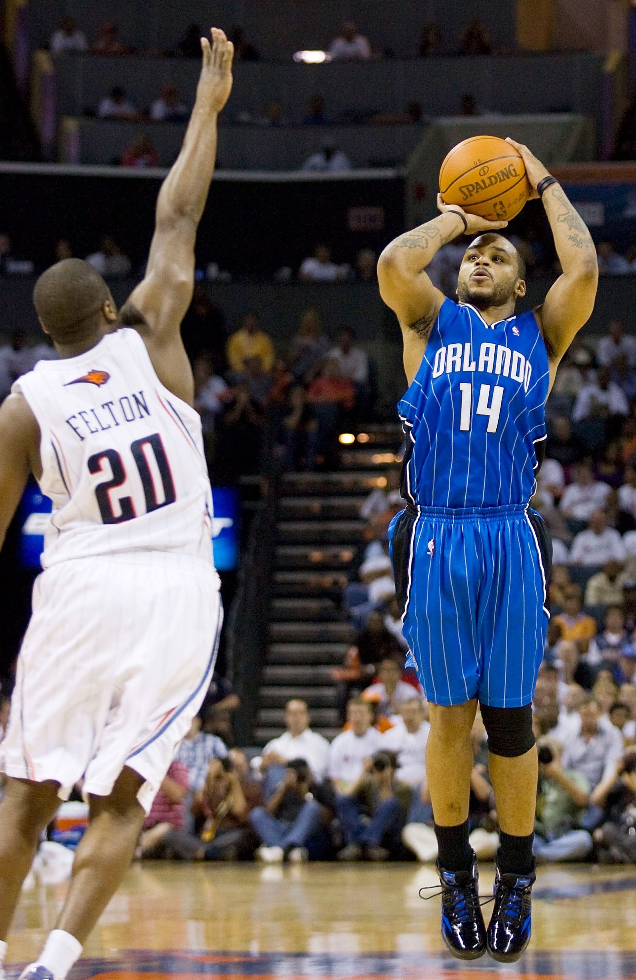 CHARLOTTE, NC - APRIL 26: Jameer Nelson #14 of the Orlando Magic shoots over the outstretched arm of Raymond Felton #20 of the Charlotte Bobcats at Time Warner Cable Arena on April 26, 2010 in Charlotte, North Carolina.  The Magic defeated the Bobcats 99-