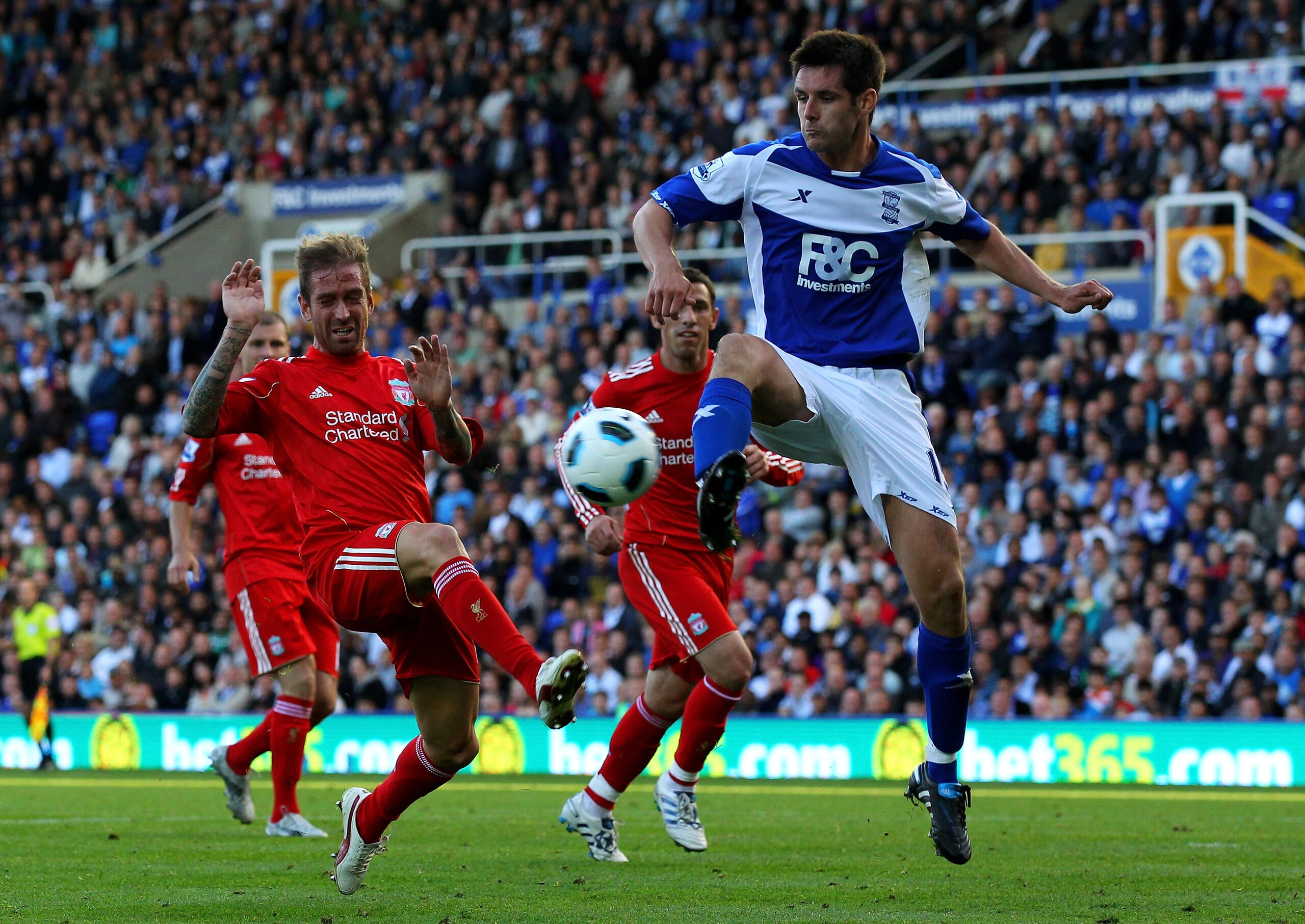 BIRMINGHAM, ENGLAND - SEPTEMBER 12:  Raul Meireles of Liverpool challenges Scott Dann of Birmingham City during the Barclays Premier League match between Birmingham City and Liverpool at St Andrew's Stadium on September 12, 2010 in Birmingham, England. (P