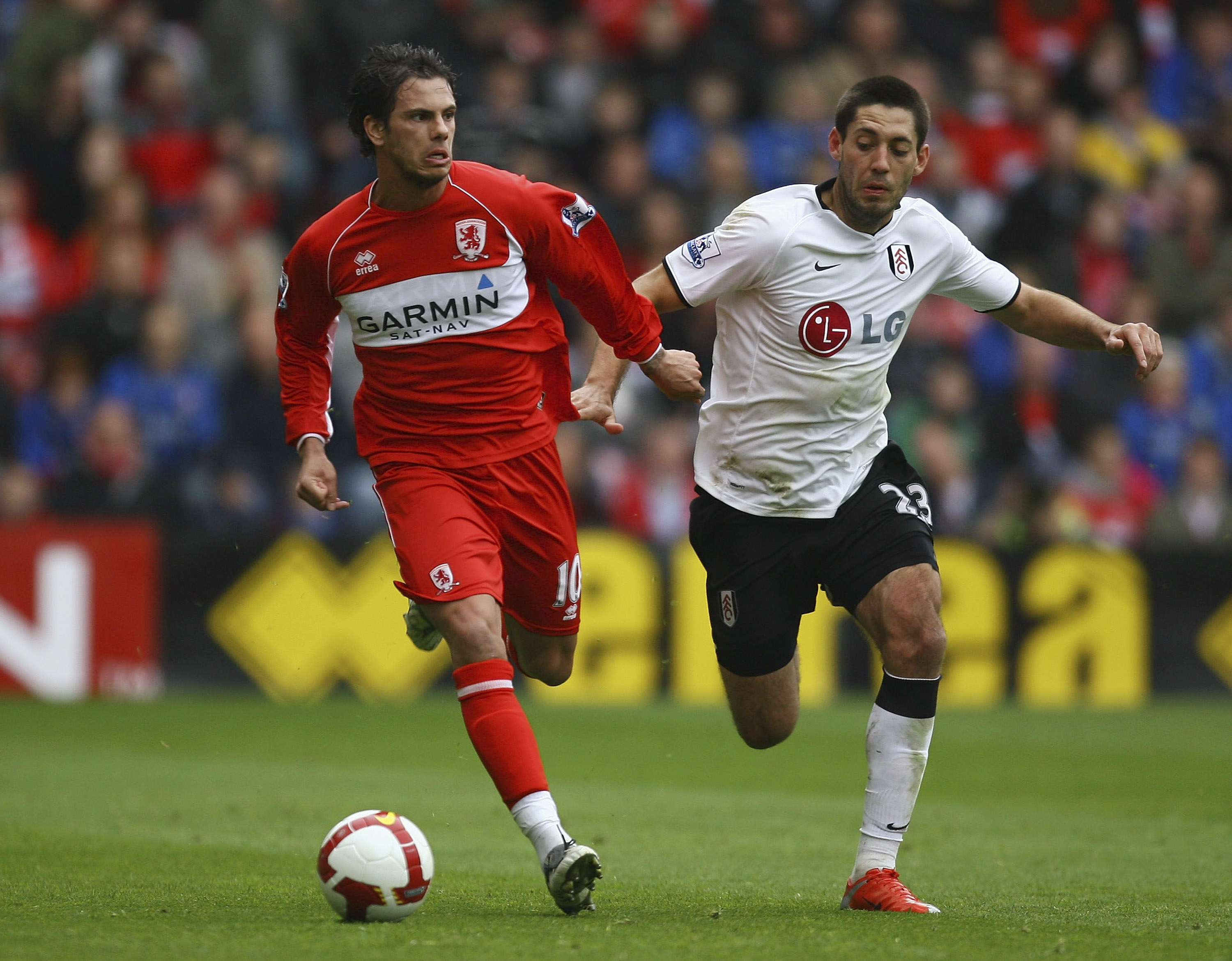 MIDDLESBROUGH, ENGLAND - APRIL 18:  Jeremie Aliadiere of Middlesbrough holds off a challenge from Clint Dempsey of Fulham during the Barclays Premier League match between Middlesbrough and Fulham at the Riverside Stadium on April 18, 2009 in Middlesbrough