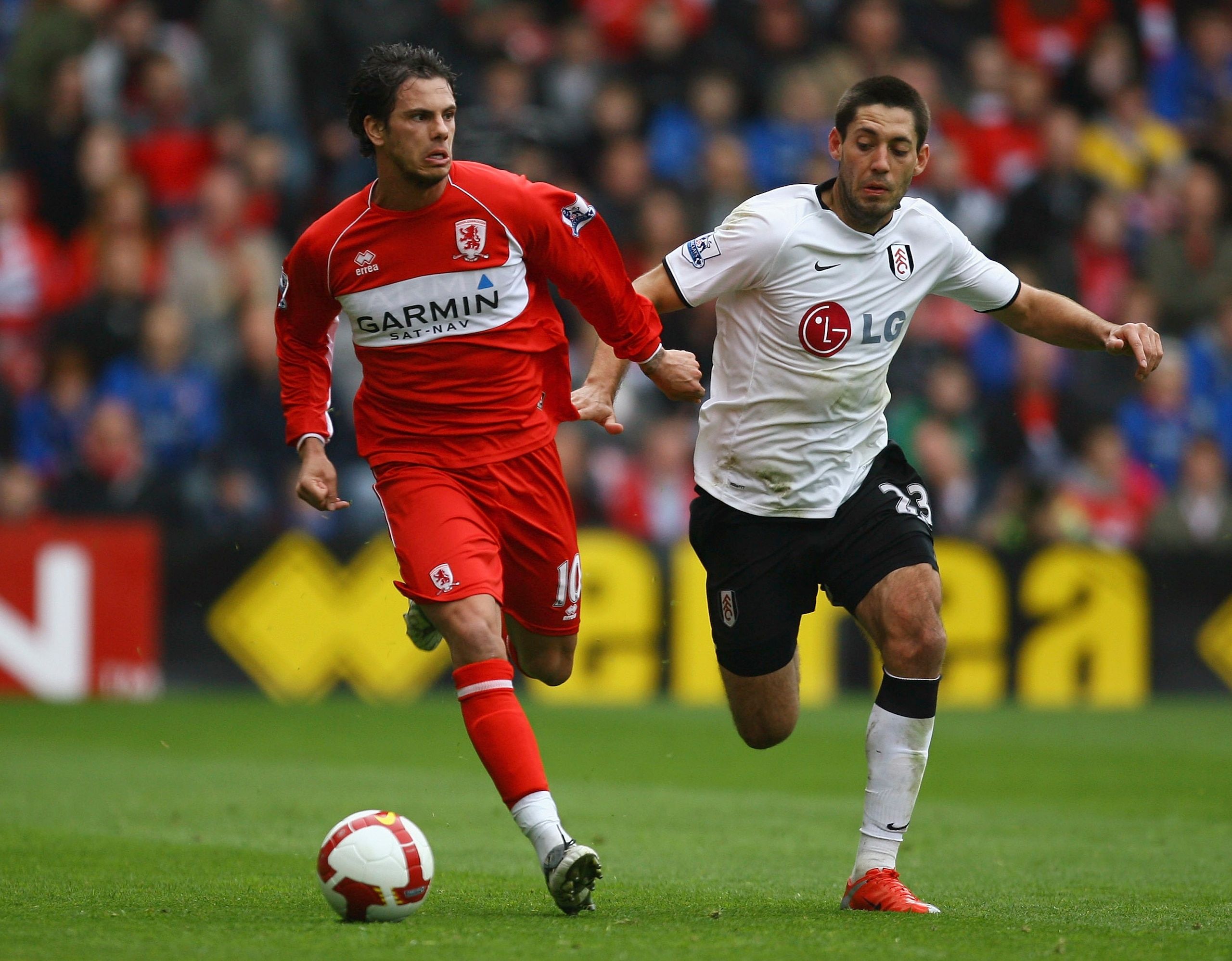 MIDDLESBROUGH, ENGLAND - APRIL 18:  Jeremie Aliadiere of Middlesbrough holds off a challenge from Clint Dempsey of Fulham during the Barclays Premier League match between Middlesbrough and Fulham at the Riverside Stadium on April 18, 2009 in Middlesbrough