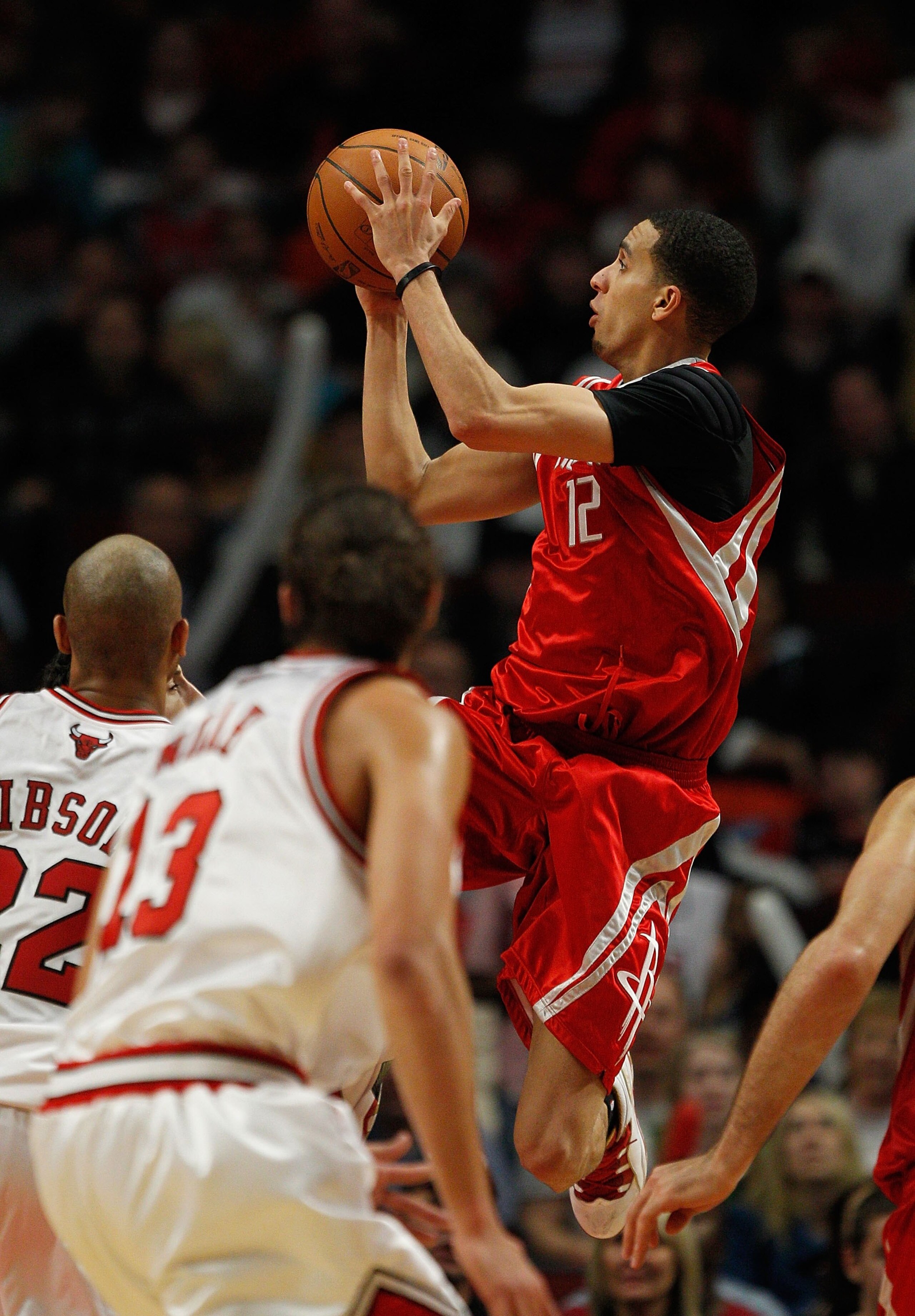 CHICAGO - MARCH 22: Kevin Martin #12 of the Houston Rockets puts up a shot over Taj Gibson #22 of the Chicago Bulls at the United Center on March 22, 2010 in Chicago, Illinois. The Bulls defeated the Rockets 98-88. NOTE TO USER: User expressly acknowledge
