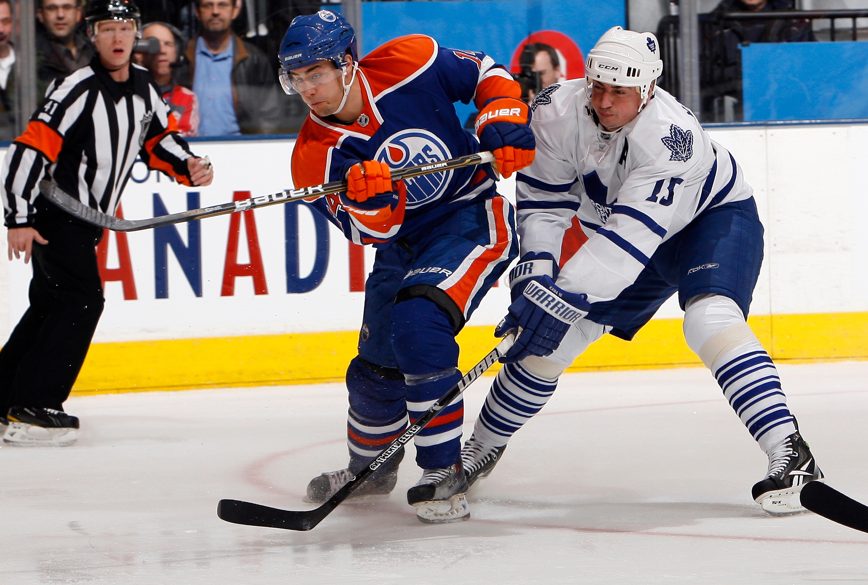 TORONTO, CANADA - DECEMBER 2: Tomas Kaberle #15 of the Toronto Maple Leafs tries to stop Jordan Eberle #14 of the Edmonton Oilers who shoots (and scores) during game action at the Air Canada Centre December 2, 2010 in Toronto, Ontario, Canada. (Photo by A