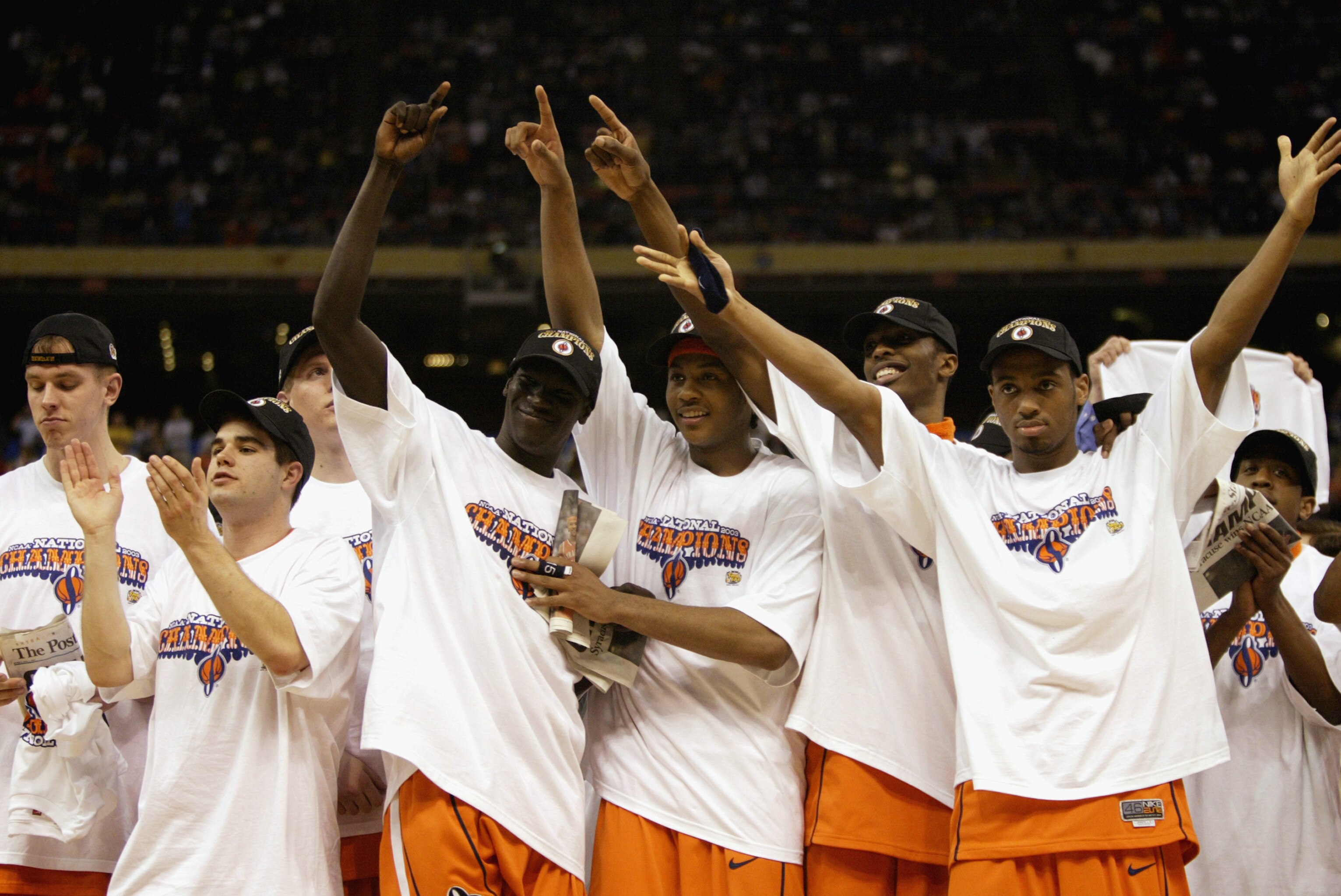 NEW ORLEANS - APRIL 7:  The Syracuse team (including Most Outstanding Player Carmelo Anthony #15, center) celebrates while wearing their championship tee shirts and caps after the victory against Kansas in the championship game of the NCAA Men's Final Fou