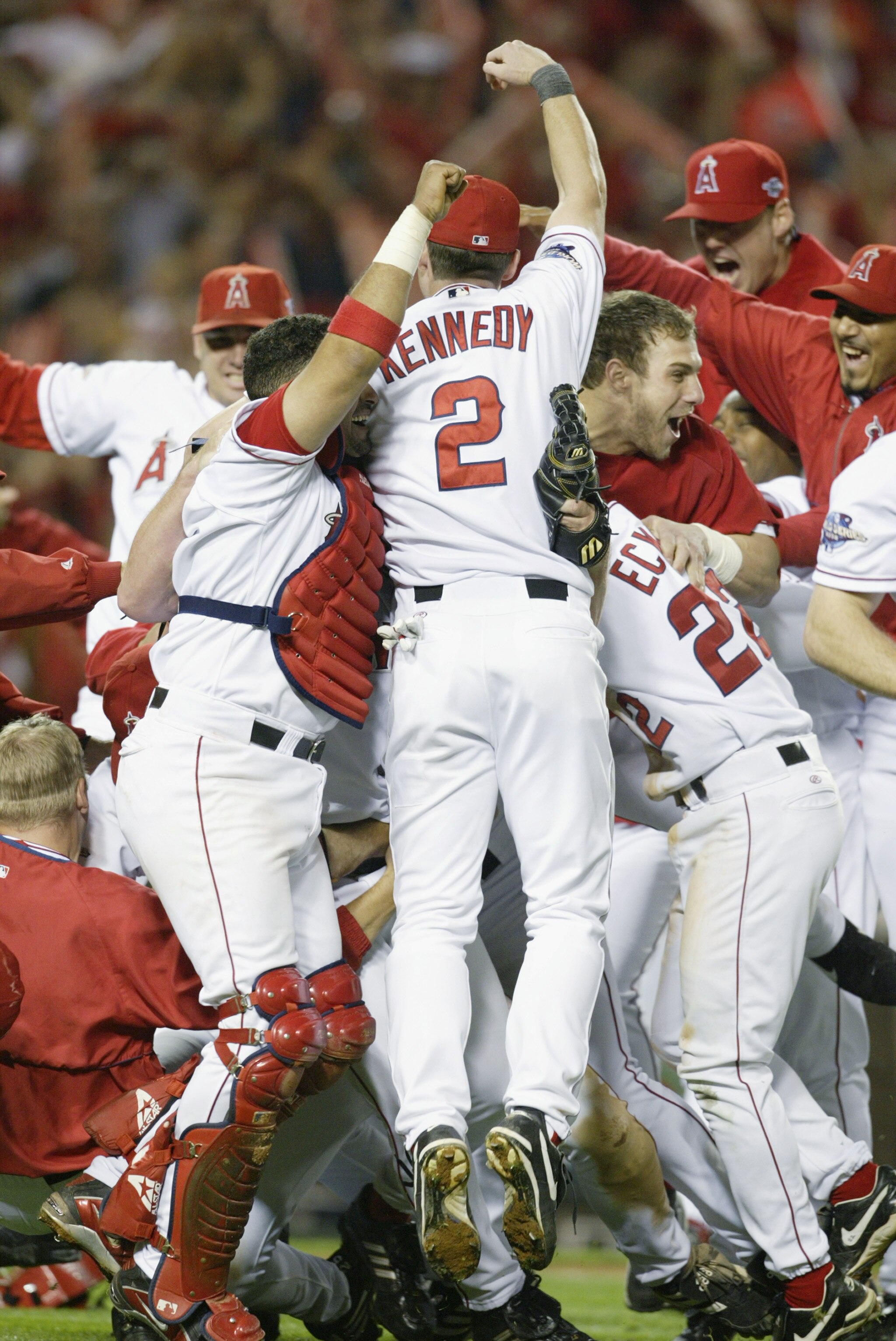 ANAHEIM, CA - OCTOBER 27:  Adam Kennedy #2 of the Anaheim Angels jumps into the celebration of teammates after the victory over the San Francisco Giants in game seven of the World Series on October 27, 2002 at Edison Field in Anaheim, California.  The Ang