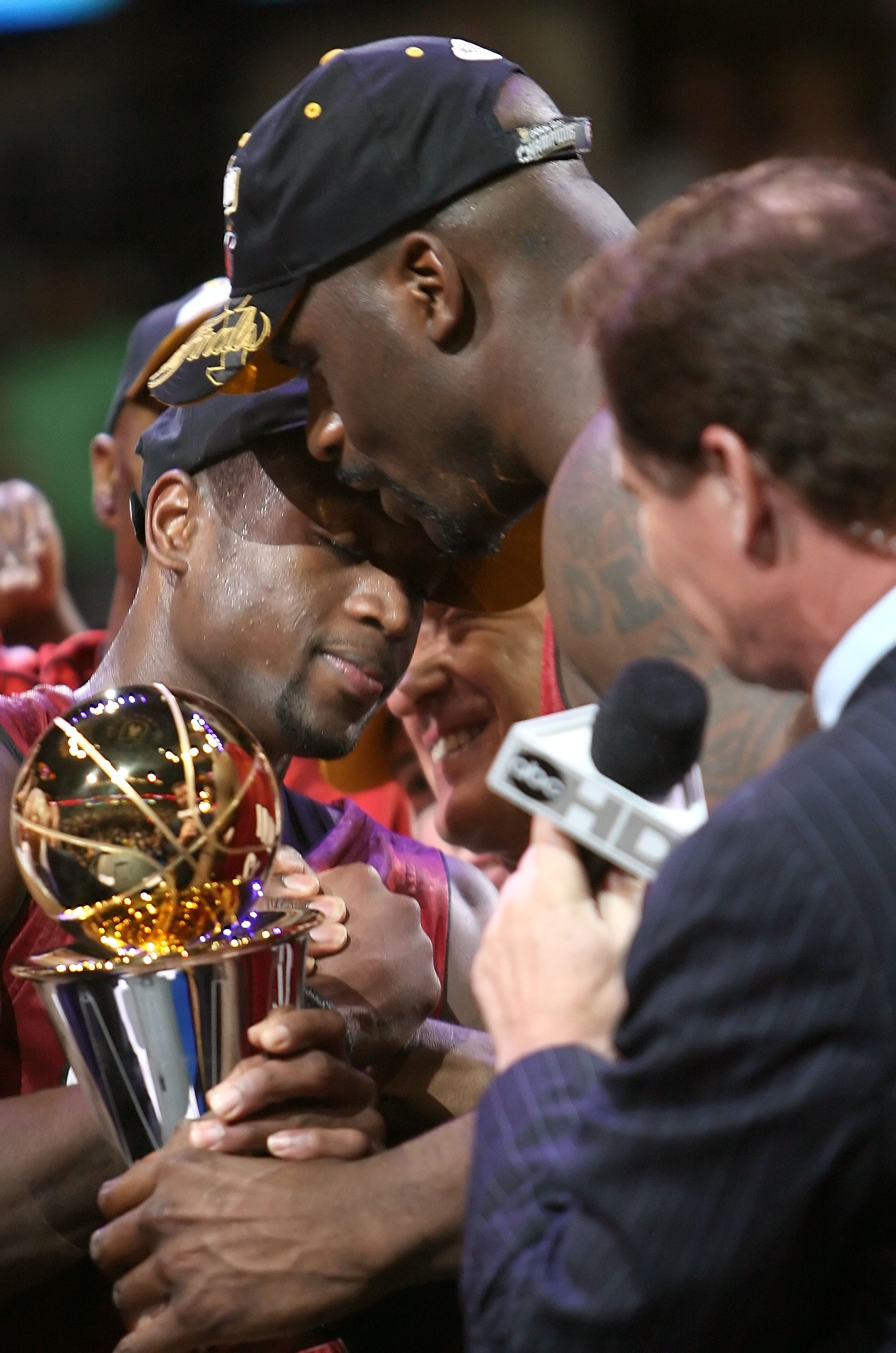 DALLAS - JUNE 20:  Shaquille O'Neal #32 hugs teammate Dwyane Wade #3 of the Miami Heat after Wade won the series MVP trophy after the Heat defeated the Dallas Mavericks in game six of the 2006 NBA Finals on June 20, 2006 at American Airlines Center in Dal