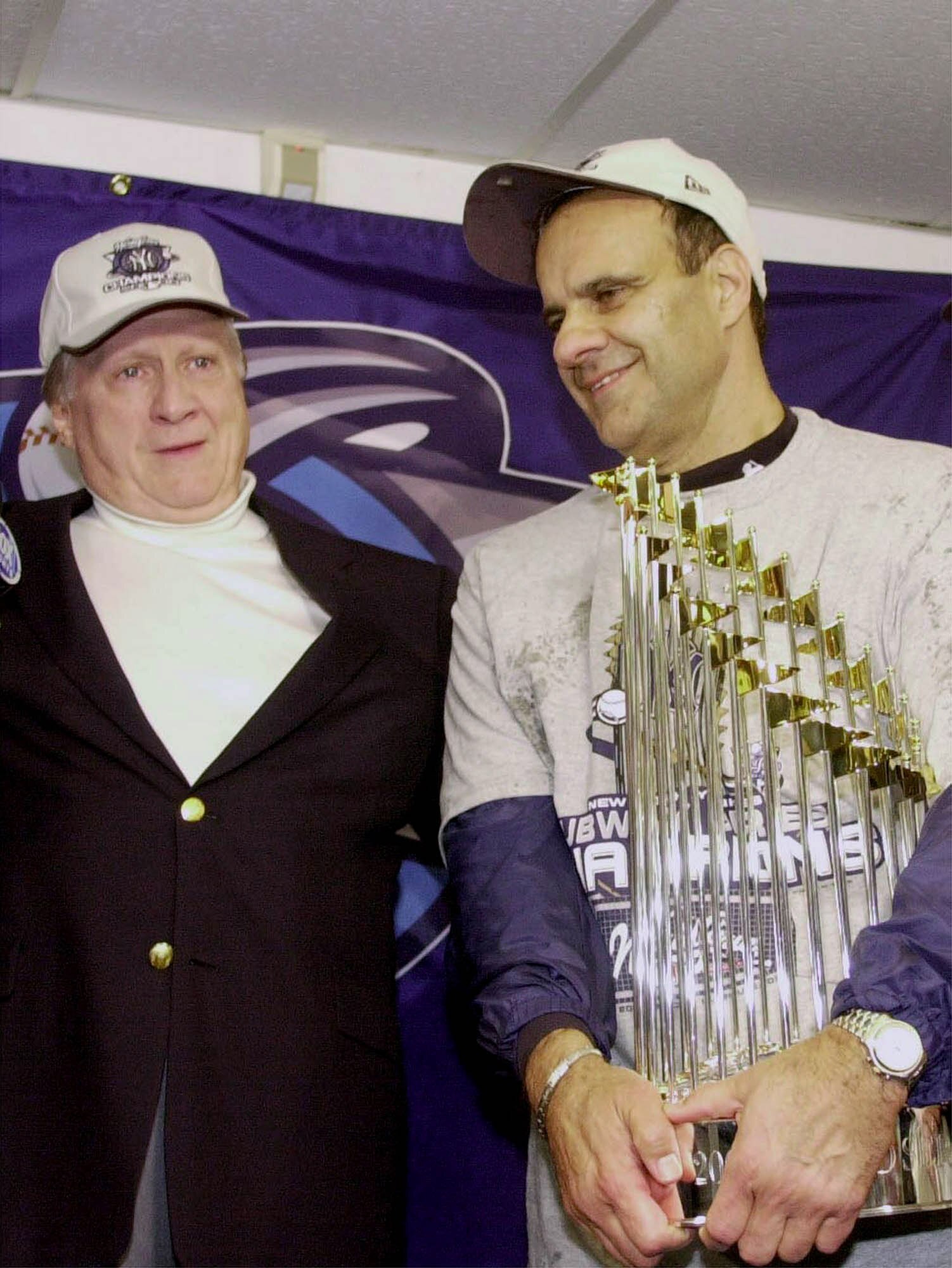 380948 03: New York Yankkees owner George Steinbrenner, left, and manager Joe Torre celebrate October 26, 2000 in the locker room after the Yanks won the World Series Championship over the New York Mets at Shea Stadium in Flushing, New York. (Photo by Ezr