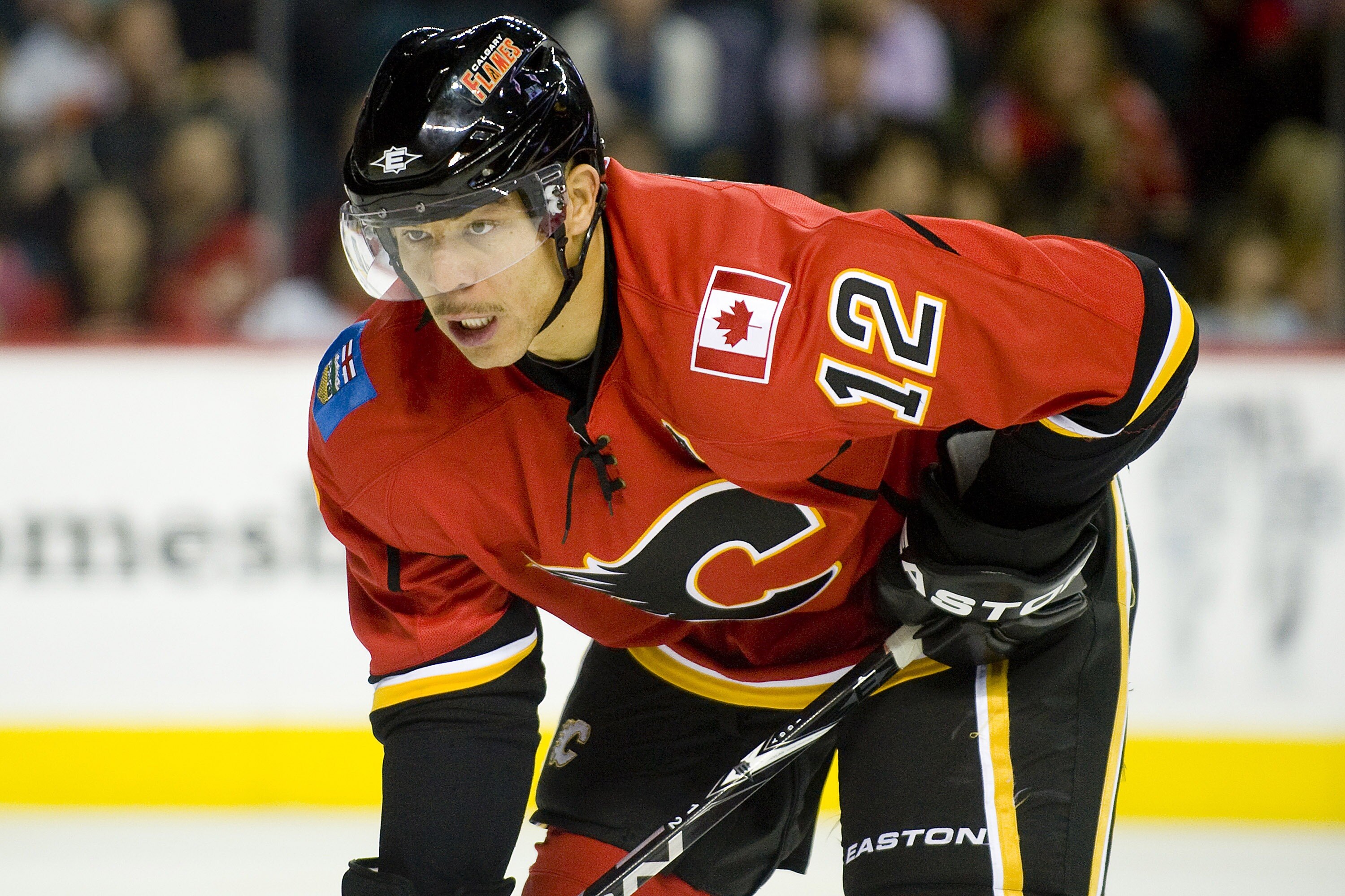 EDMONTON, AB - NOVEMBER 29:  Jarome Iginla #12 of the Calgary Flames concentrates on the puck during a game against the Minnesota Wild at Scotiabank Saddledome on November 29, 2010 in Calgary, Alberta, Canada. The Flames beat the Wild 3-0.  (Photo by Dyla