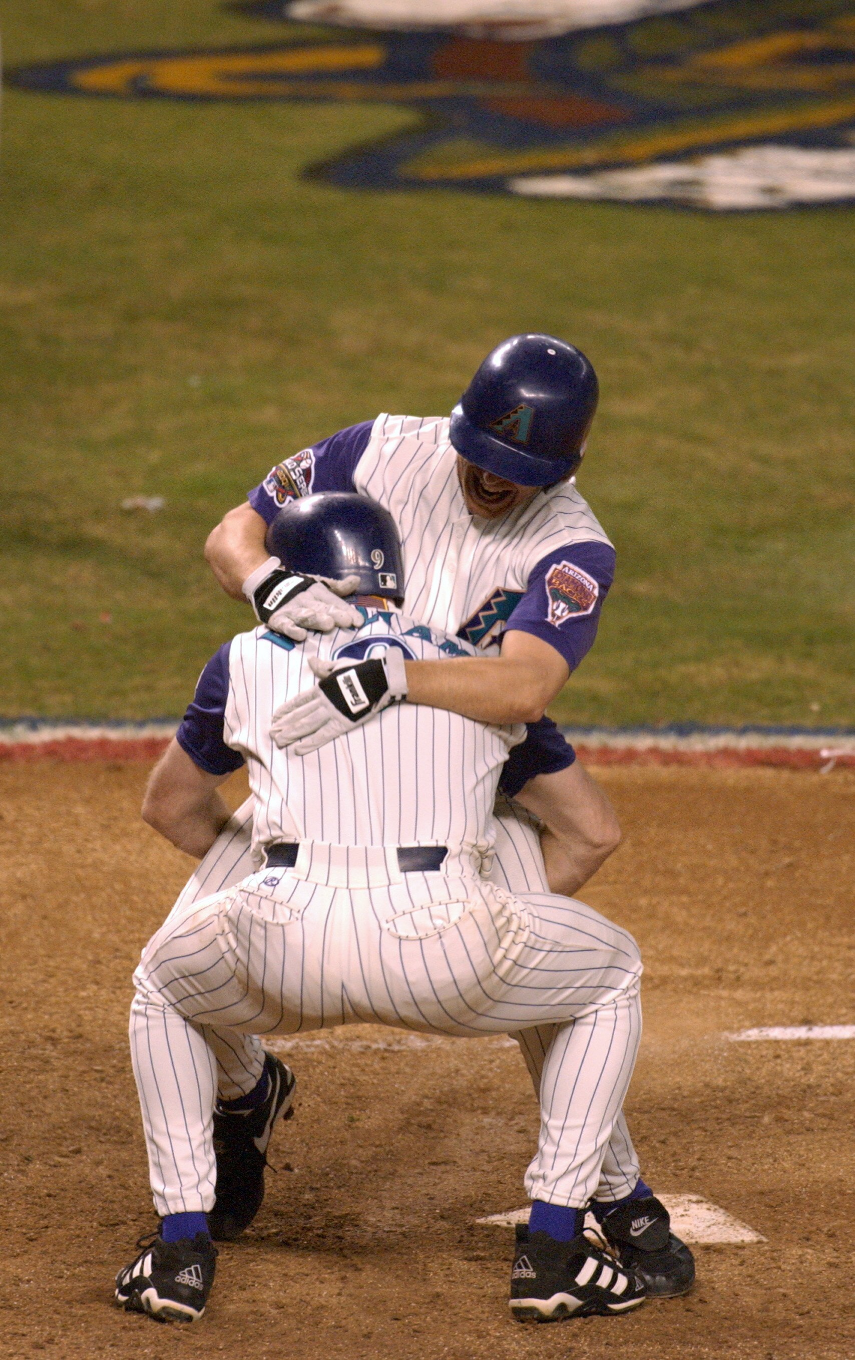 4 Nov 2001: Jay Bell #48 of the Arizona Diamondbacks is met at home plate by teammate Matt Williams #9 as he scores the winning run in the ninth inning against the New York Yankees during game seven of the Major League Baseball World Series at Bank One Ba