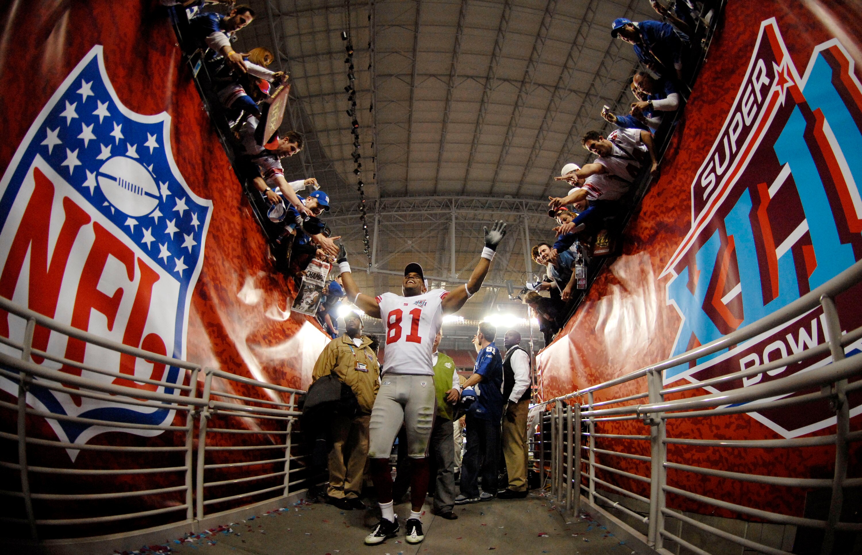 GLENDALE, AZ - FEBRUARY 03:  Amani Toomer #81 of the New York Giants walks off the field after defeating the New England Patriots 17-14 in Super Bowl XLII on February 3, 2008 at the University of Phoenix Stadium in Glendale, Arizona.  (Photo by Michael He