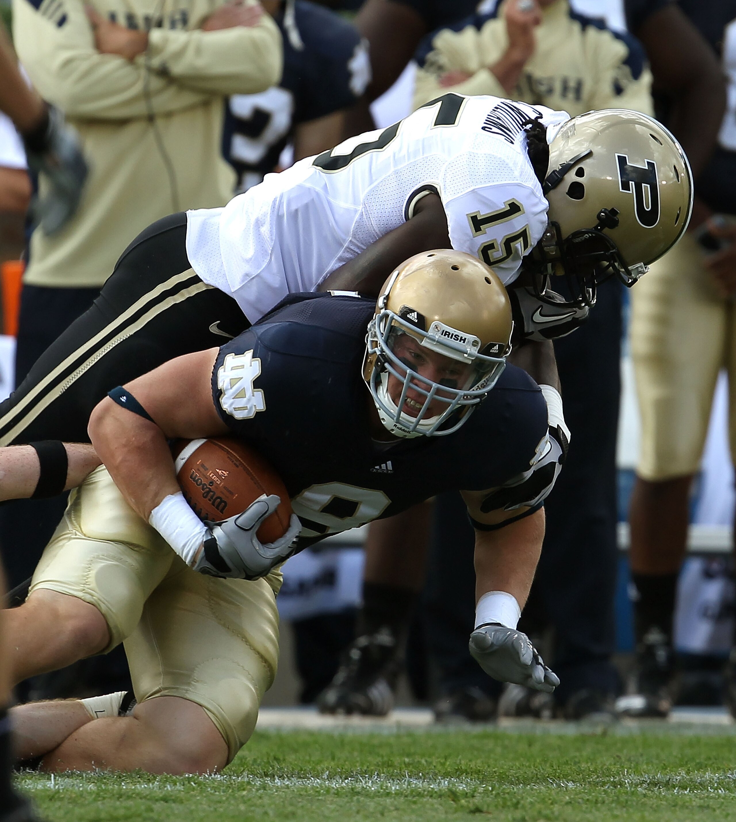 SOUTH BEND, IN - SEPTEMBER 04: Kyle Rudolph #9 of the Notre Dame Fighting Irish is tackled by Charlton Williams #15 of the Purdue Boilermakers at Notre Dame Stadium on September 4, 2010 in South Bend, Indiana. Notre Dame defeated Purdue 23-12. (Photo by J