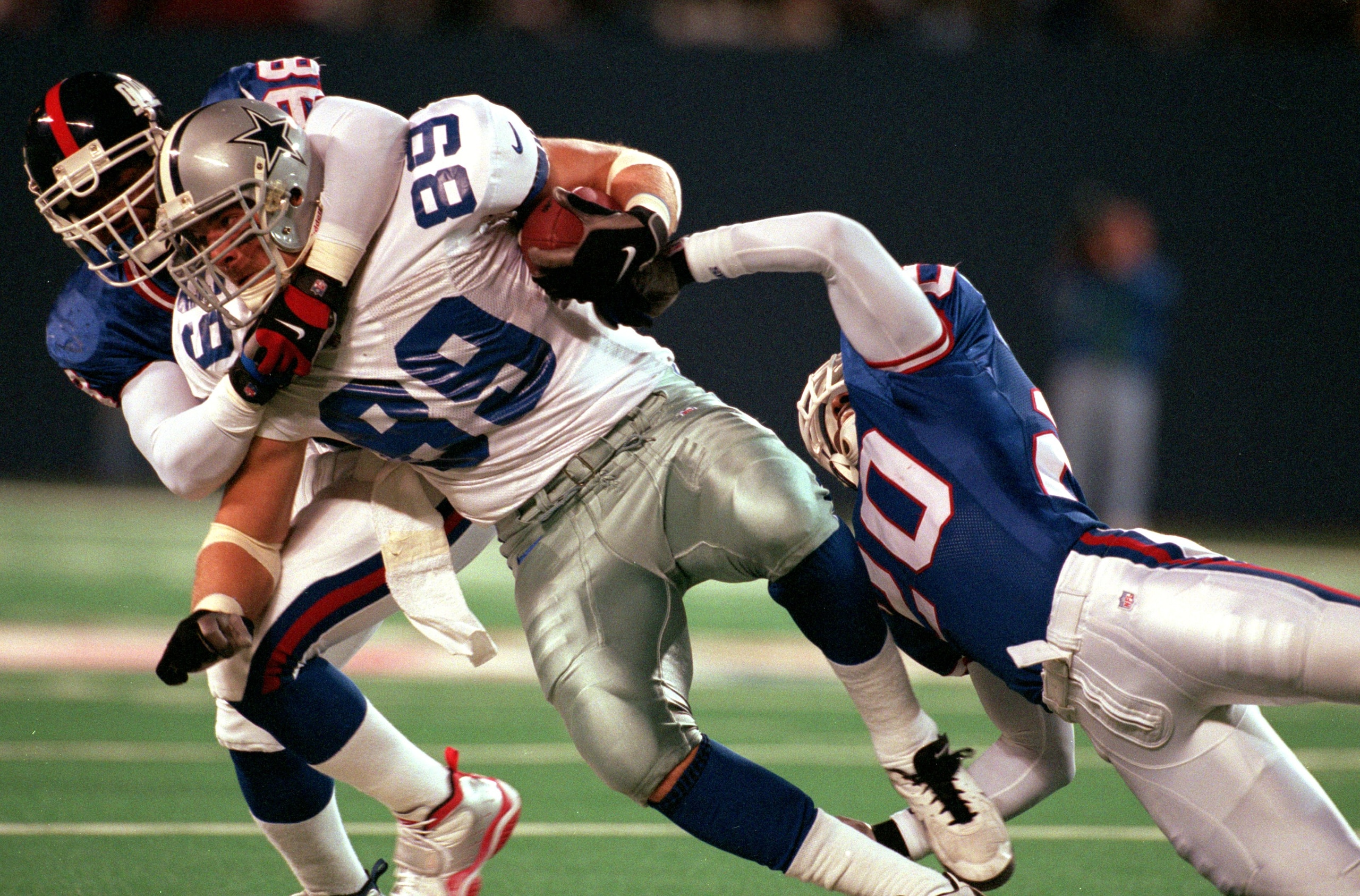 18 Oct 1999:  David Lafleur #89 of the New York Giants tackles Jesse Armstrong #98 of the Dallas Cowboys at the Giants Stadium in East Rutherford, New Jersey. The Giants defeated the Cowboys 16-13. Mandatory Credit: Ezra O. Shaw  /Allsport