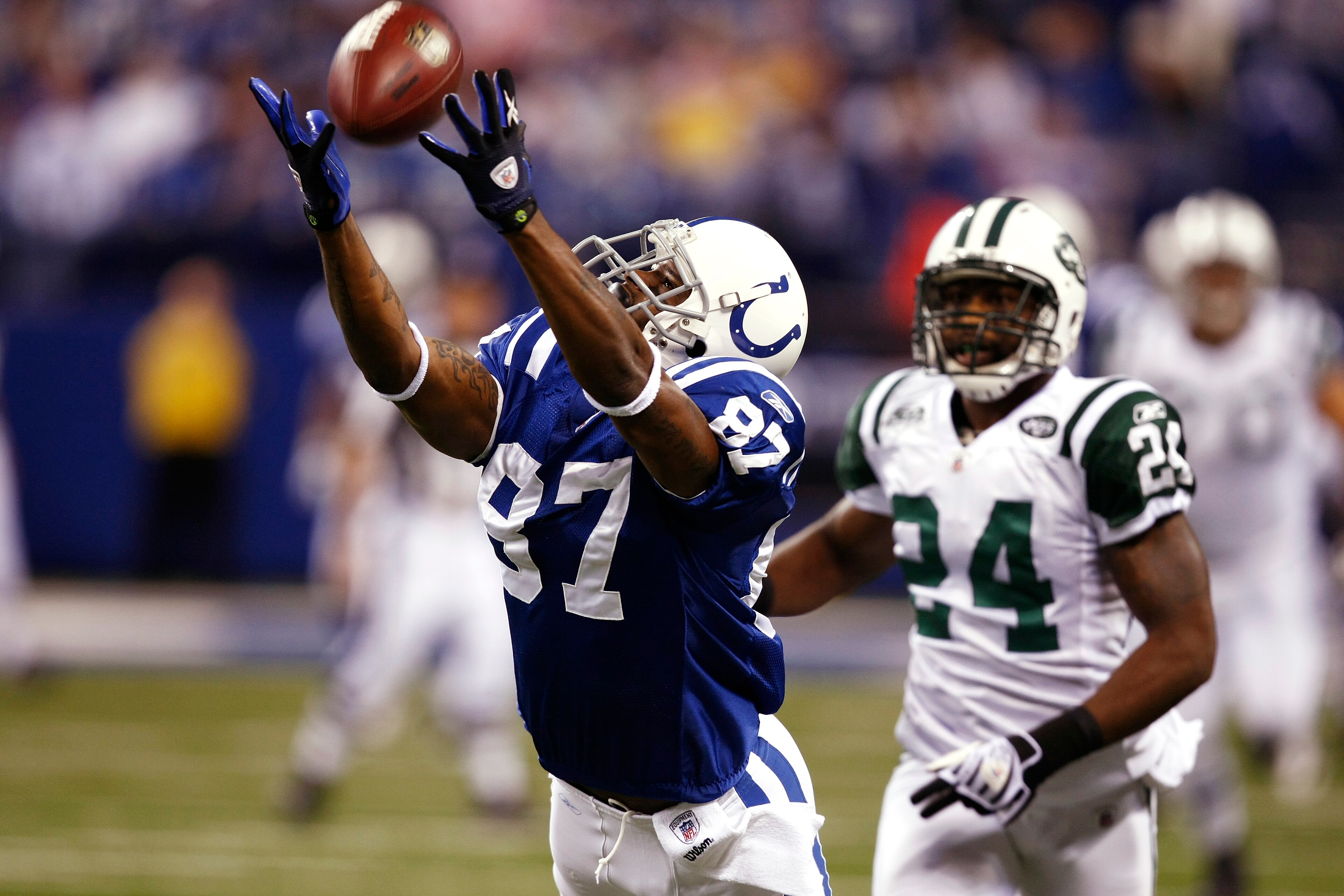 INDIANAPOLIS, IN - DECEMBER 27: Reggie Wayne #87 of the Indianapolis Colts tries to make a reception behind Darrelle Revis #24 of the New York Jets at Lucas Oil Stadium on December 27, 2009 in Indianapolis, Indiana. The Jets handed the Colts their first l