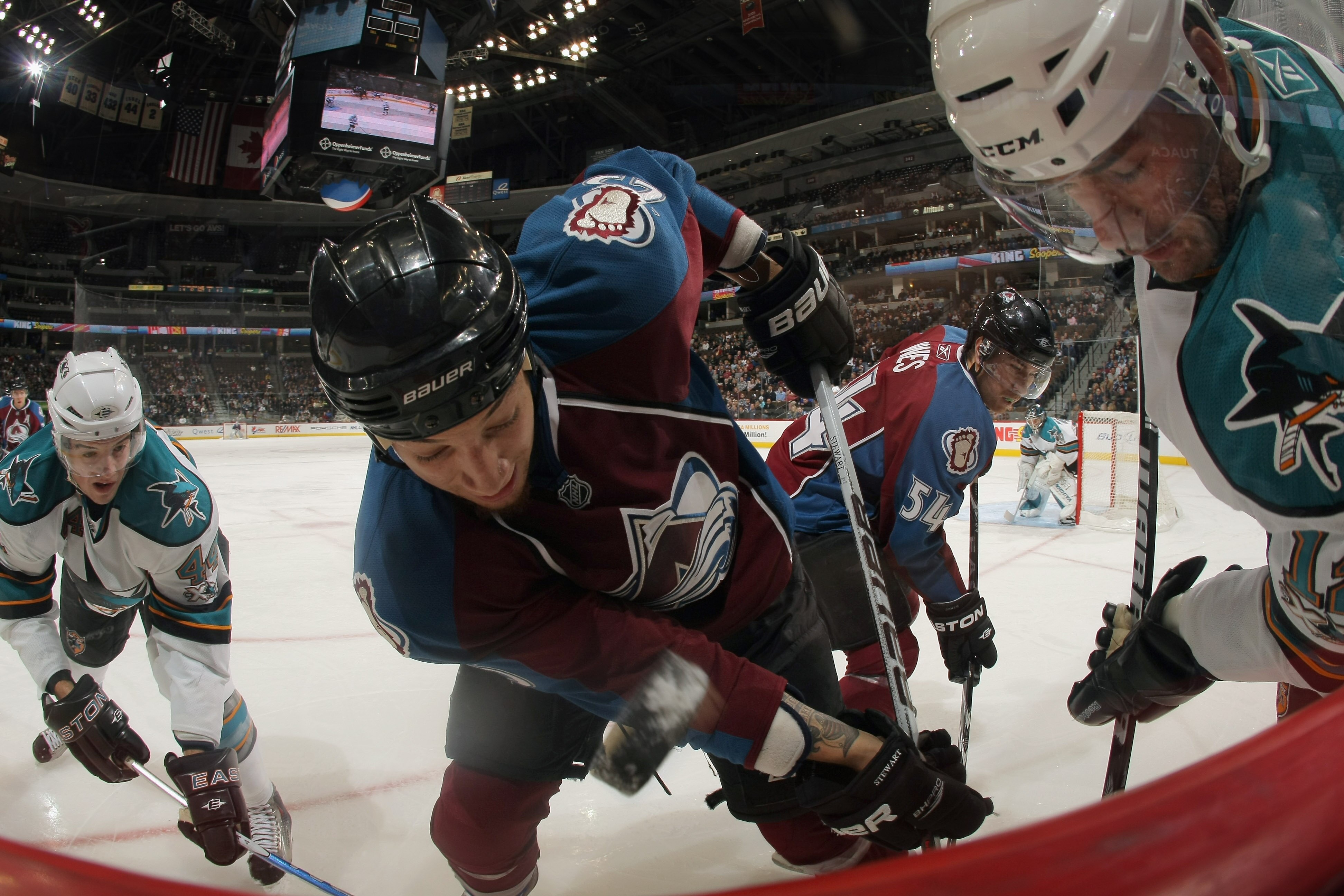 DENVER - NOVEMBER 17:  Chris Stewart #25 of the Colorado Avalanche battles for the puck between Marc-Edouad Vlasic #44 and Patrick Marleau #12 of the San Jose Sharks at the Pepsi Center on November 17, 2010 in Denver, Colorado. The Avalanche defeated the