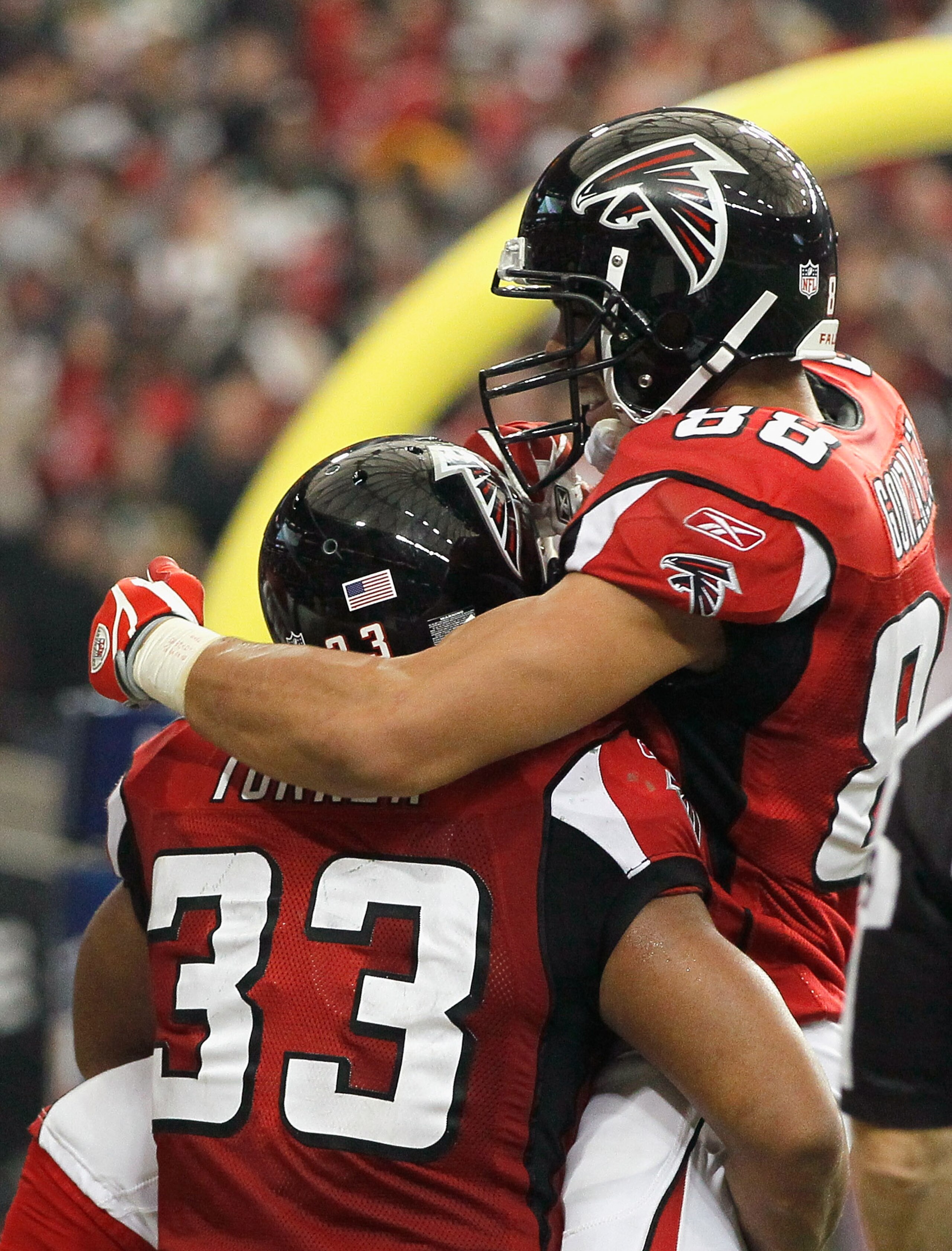 ATLANTA - NOVEMBER 28:  Tony Gonzalez #88 and Michael Turner #33 of the Atlanta Falcons celebrate Turner's touchdown against the Green Bay Packers at Georgia Dome on November 28, 2010 in Atlanta, Georgia.  (Photo by Kevin C. Cox/Getty Images)