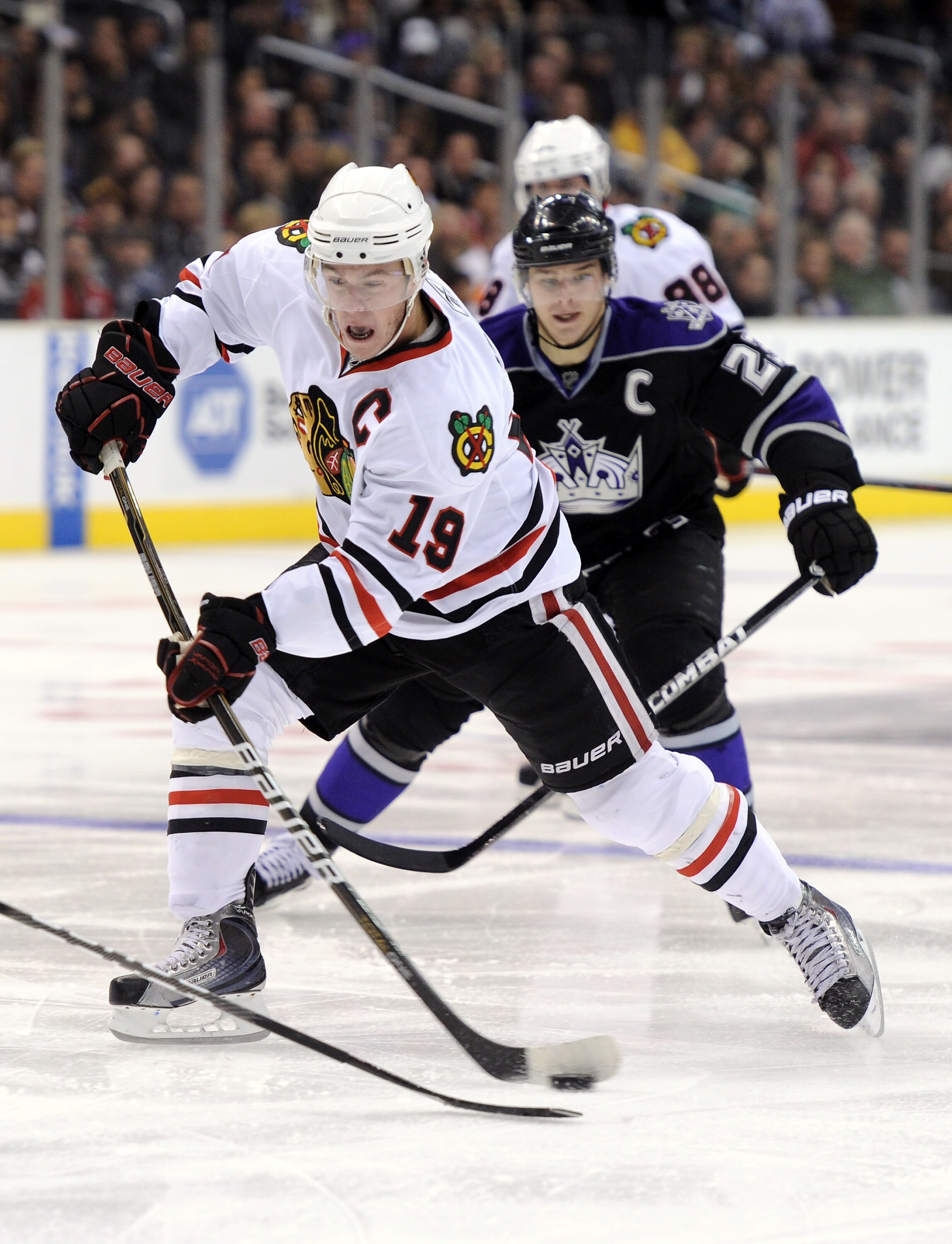 LOS ANGELES, CA - NOVEMBER 27:  Jonathan Toews #19 of the Chicago Blackhawks takes a shot in front of Dustin Brown #23 of the Los Angeles Kings at Staples Center on November 27, 2010 in Los Angeles, California.  (Photo by Harry How/Getty Images)