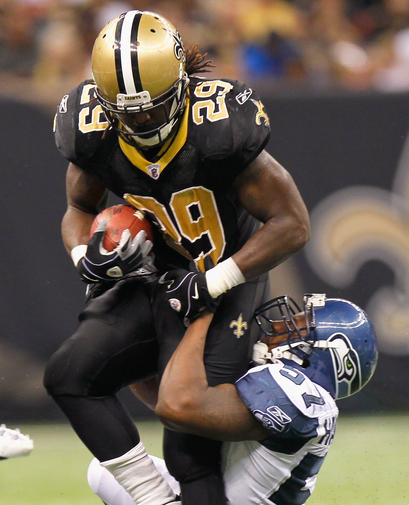 NEW ORLEANS - NOVEMBER 21:  Chris Ivory #29 of the New Orleans Saints is tackled by David Hawthorne #57 of the Seattle Seahawks at Louisiana Superdome on November 21, 2010 in New Orleans, Louisiana.  (Photo by Kevin C. Cox/Getty Images)