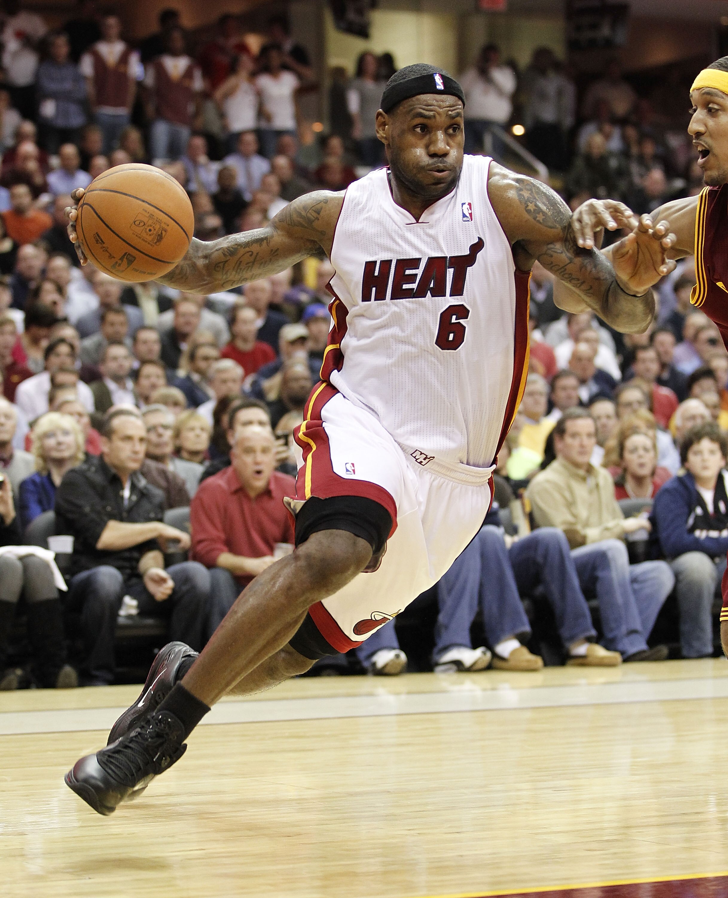 CLEVELAND, OH - DECEMBER 02:  LeBron James #6 of the Miami Heat drives around Jamario Moon #15 of the Cleveland Cavaliers at Quicken Loans Arena on December 2, 2010 in Cleveland, Ohio. NOTE TO USER: User expressly acknowledges and agrees that, by download