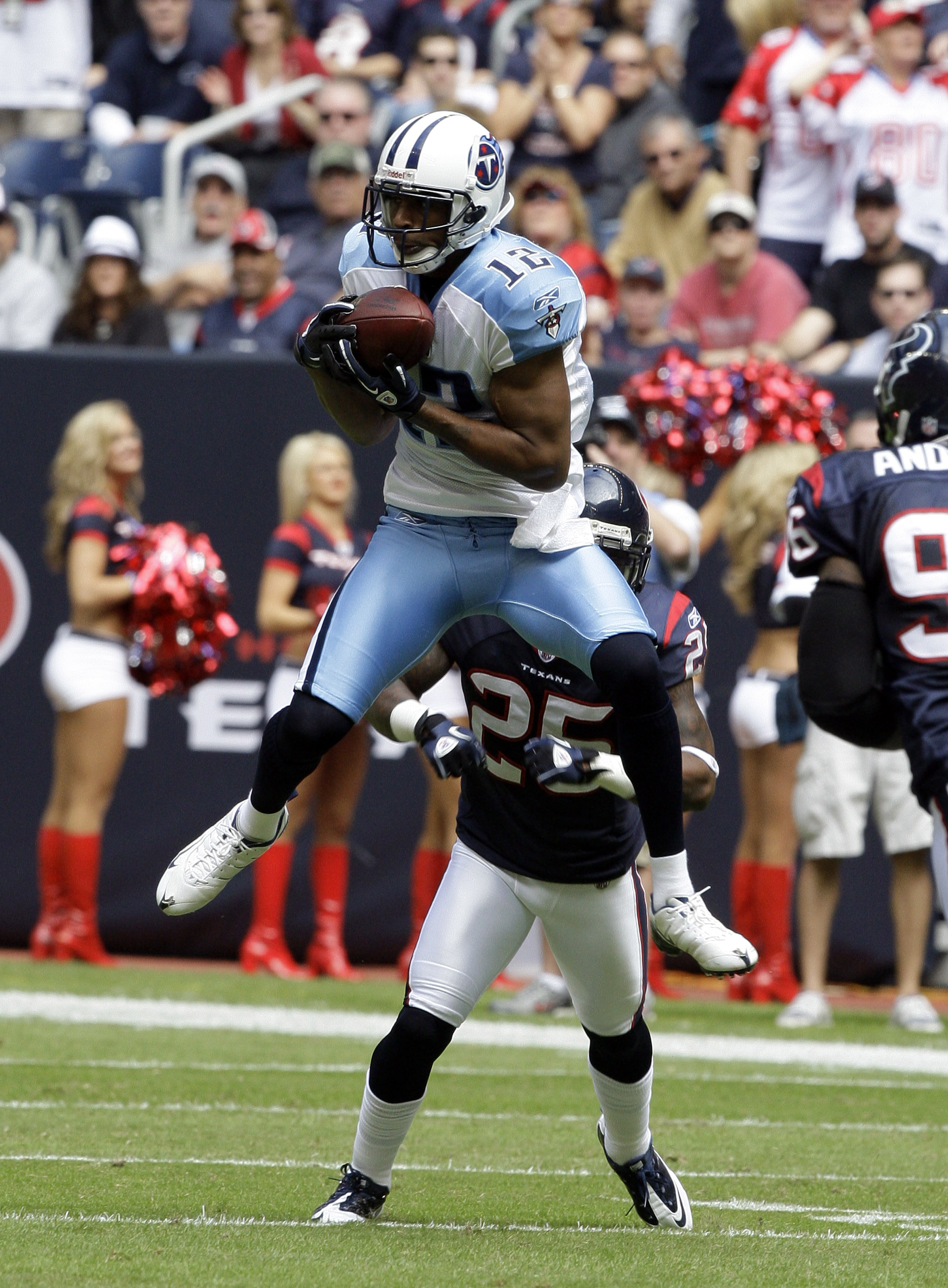 HOUSTON - NOVEMBER 28:  Wide receive Justin Gage #12 of the Tennessee Titans makes a catch in front of cornerback Kareem Jackson in the first quarter at Reliant Stadium on November 28, 2010 in Houston, Texas.  (Photo by Bob Levey/Getty Images)