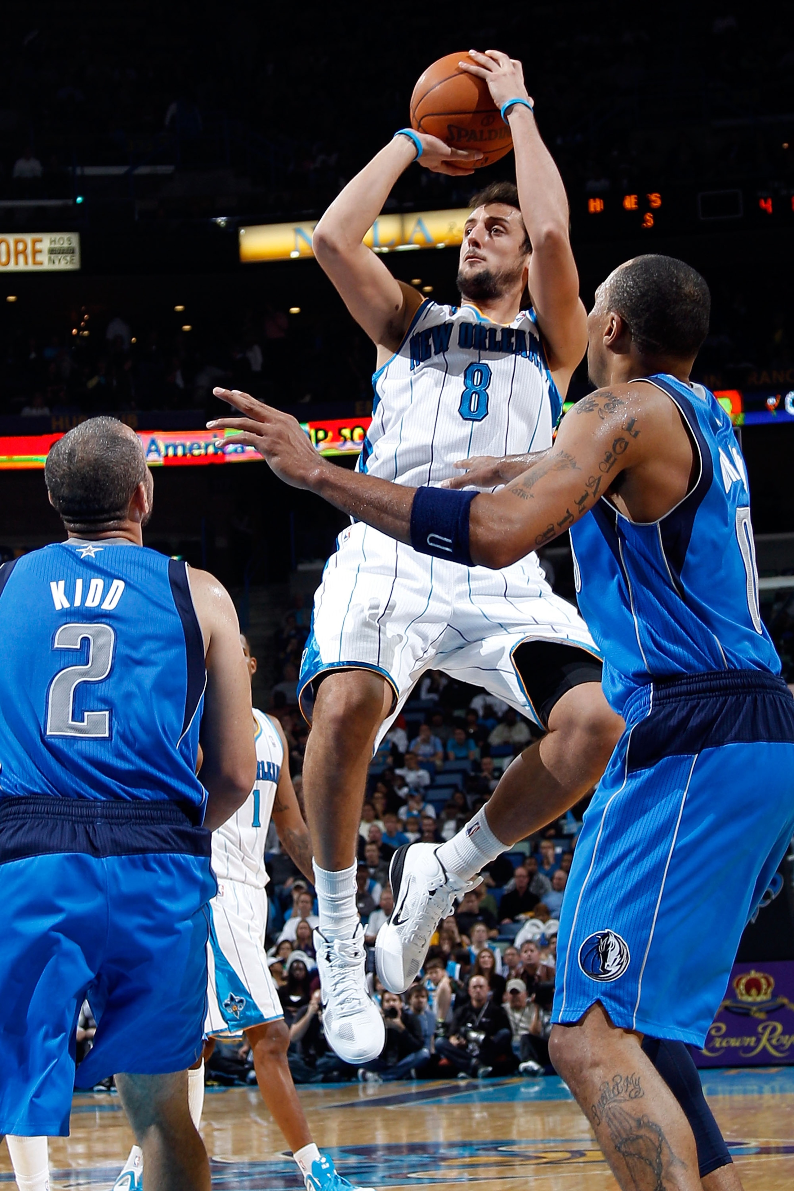 NEW ORLEANS - NOVEMBER 17:  Marco Belinelli #8 of the New Orleans Hornets shoots the ball over Shawn Marion #0 of the Dallas Mavericks at the New Orleans Arena on November 17, 2010 in New Orleans, Louisiana.  NOTE TO USER: User expressly acknowledges and