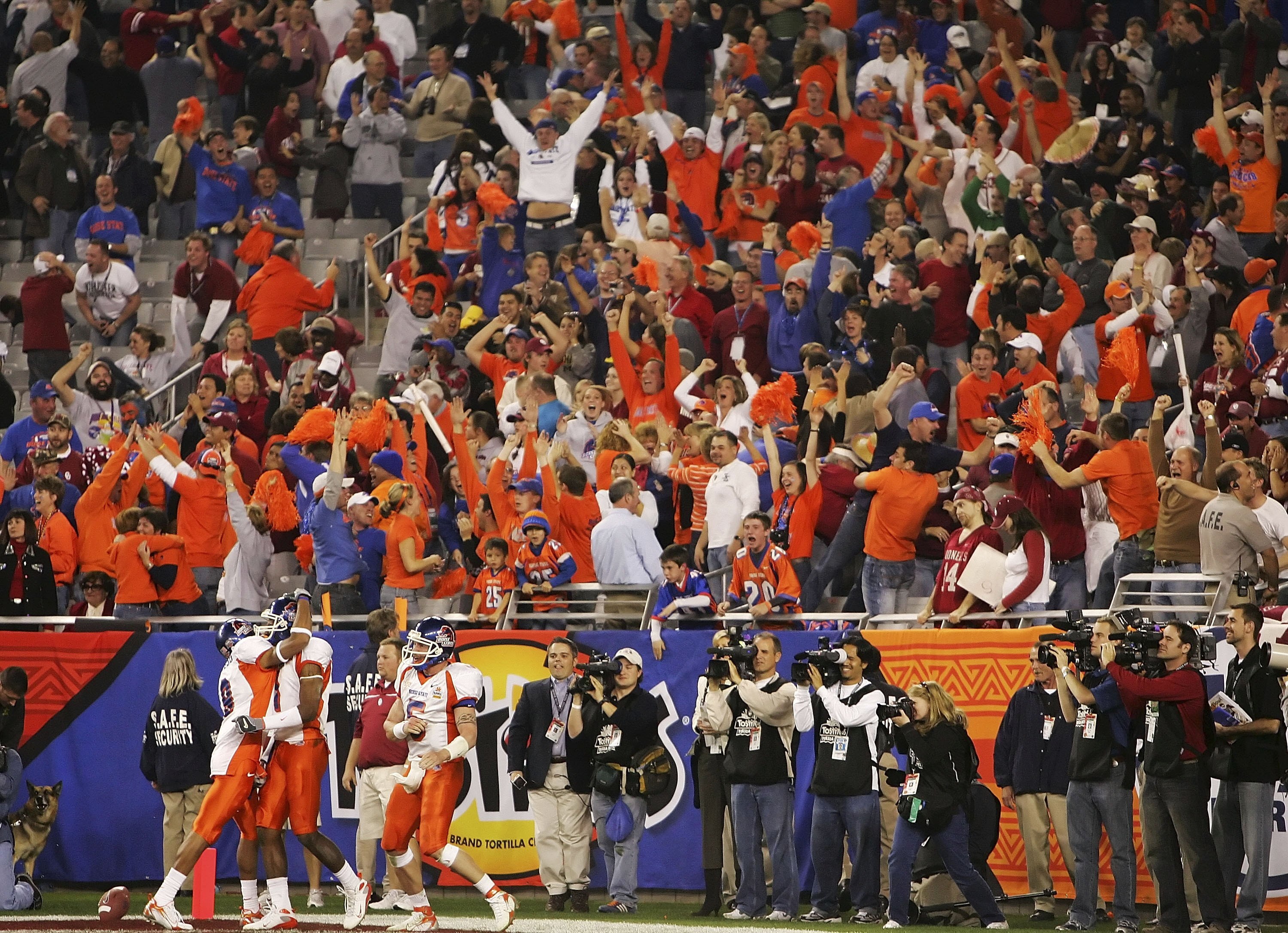 GLENDALE, AZ - JANUARY 01:  (L-R) Jeremy Childs #9, Jerad Rabb #1 and Jared Zabransky #5 of the Boise State Broncos celebrates the Rabb touchdown late in the fourth quarter against the Oklahoma Sooners at the Tostito's Fiesta Bowl at University of Phoenix