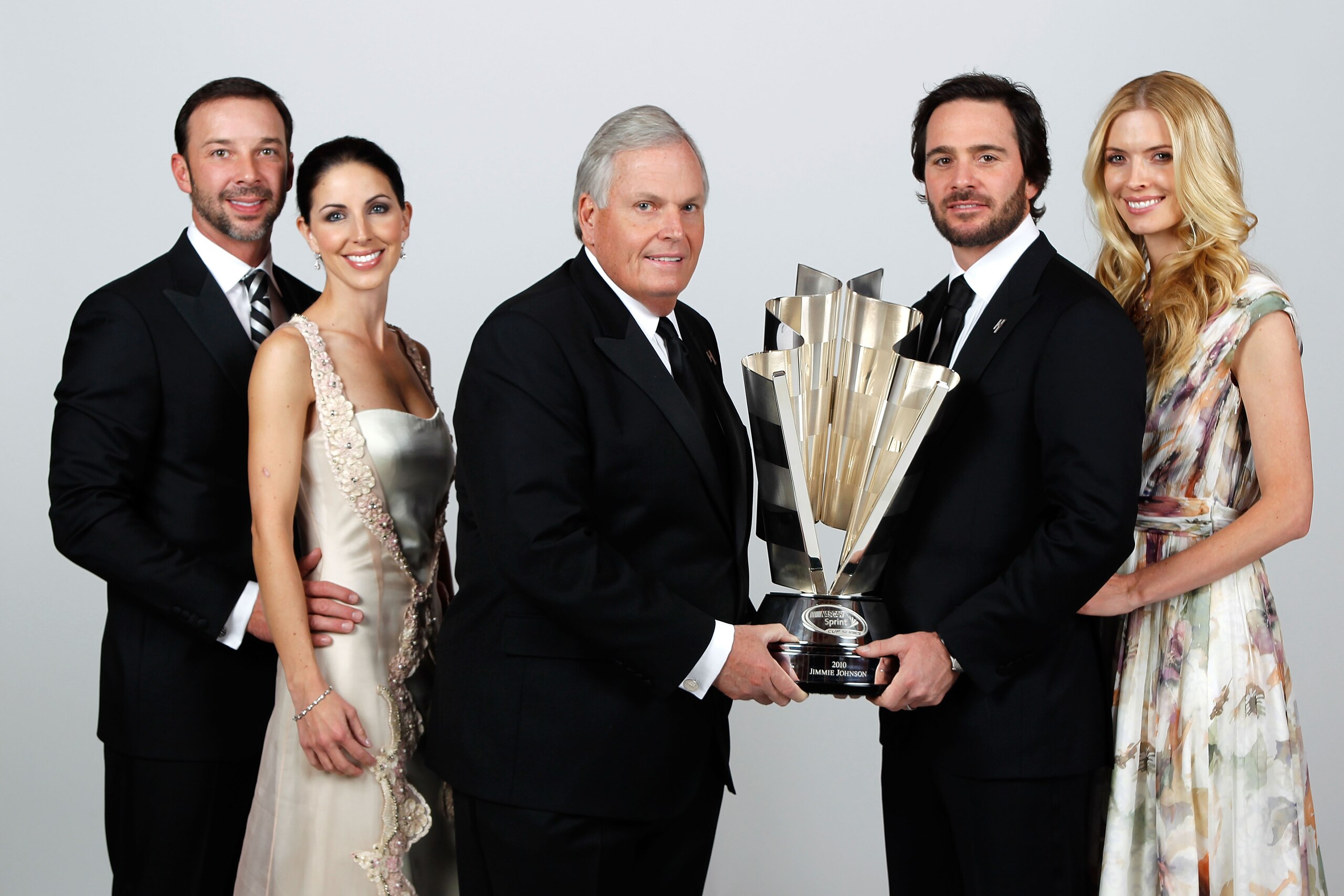 LAS VEGAS, NV - DECEMBER 03:  (L-R) Crew chief Chad Knaus, girlfriend Lisa Rockelmann, team owner Rick Hendrick, five-time champion Jimmie Johnson, and his wife Chandra pose during the NASCAR Sprint Cup Series awards banquet at the Wynn Las Vegas Hotel on