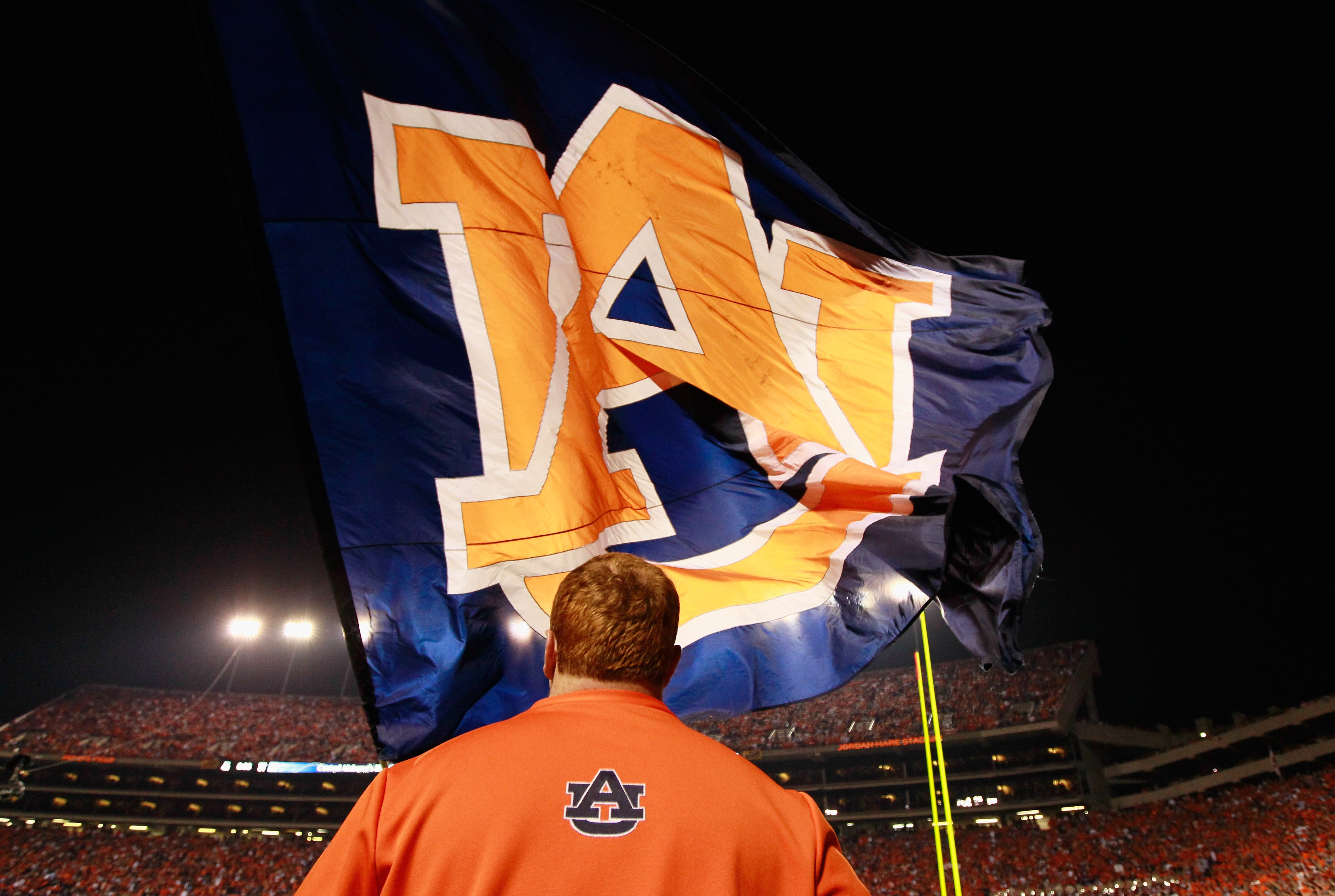 AUBURN, AL - NOVEMBER 13:  Cheerleaders of the Auburn Tigers wave one of their giant flags against the Georgia Bulldogs at Jordan-Hare Stadium on November 13, 2010 in Auburn, Alabama.  (Photo by Kevin C. Cox/Getty Images)