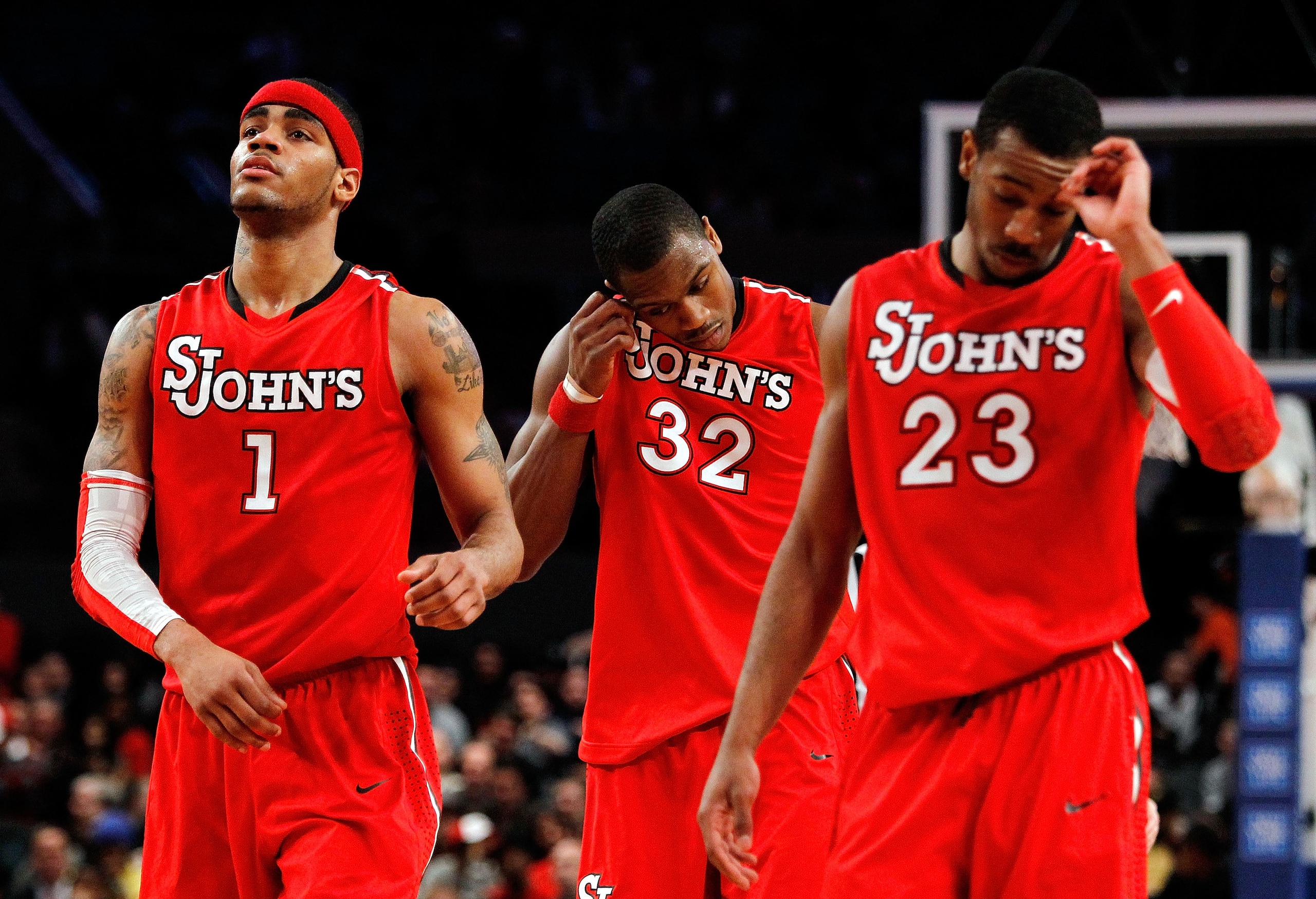 NEW YORK - MARCH 10: D.J. Kennedy #1, Justin Brownlee #32 and Paris Horne #23 of the St. John's Red Storm look on towards the end of their game against the Marquette Golden Eagles during the second round of 2010 NCAA Big East Tournament at Madison Square
