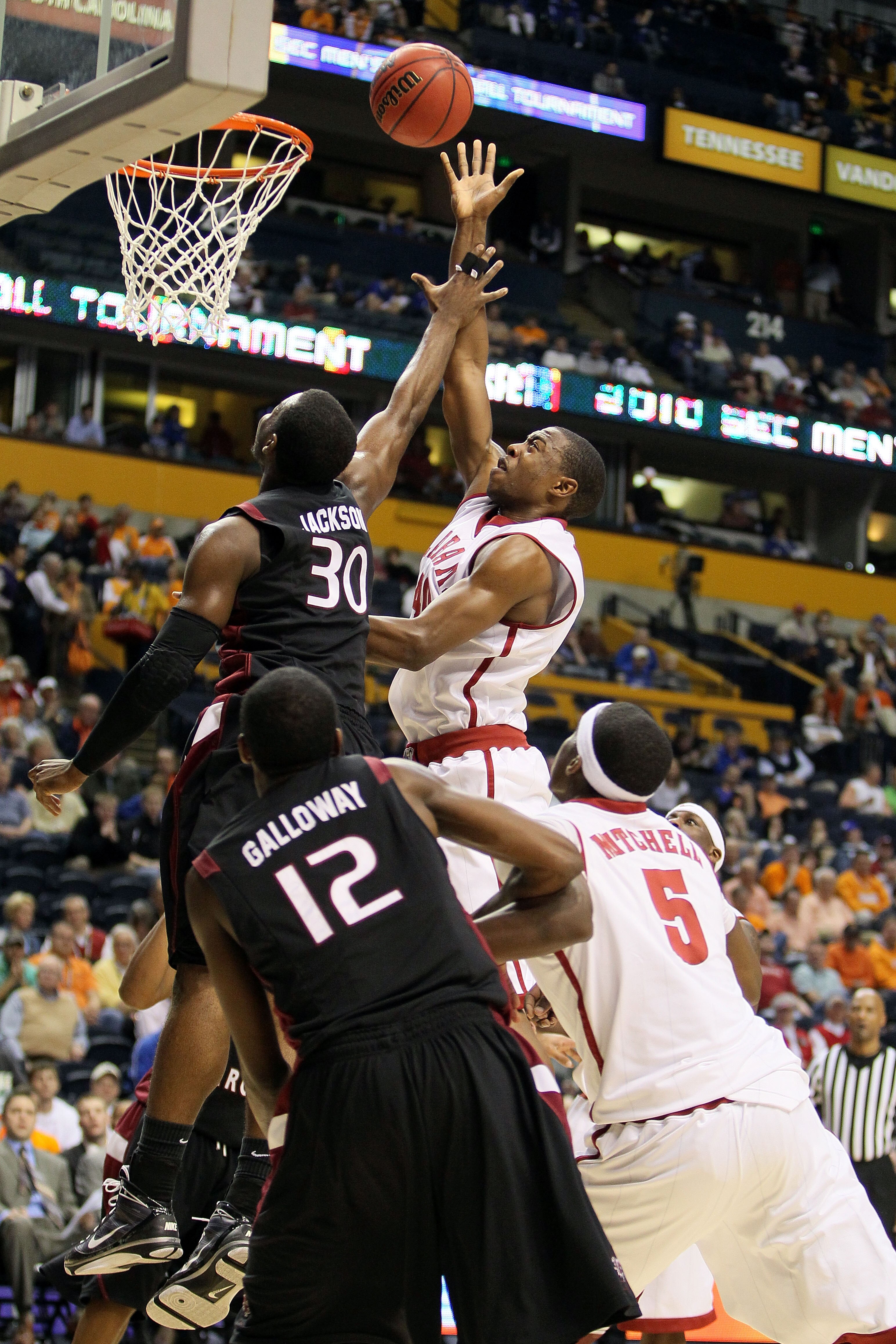 NASHVILLE, TN - MARCH 11:  Justin Knox #40 of the Alabama Crimson Tide attempts a shot against Lakeem Jackson #30 of the South Carolina Gamecocks during the first round of the SEC Men's Basketball Tournament at the Bridgestone Arena on March 11, 2010 in N