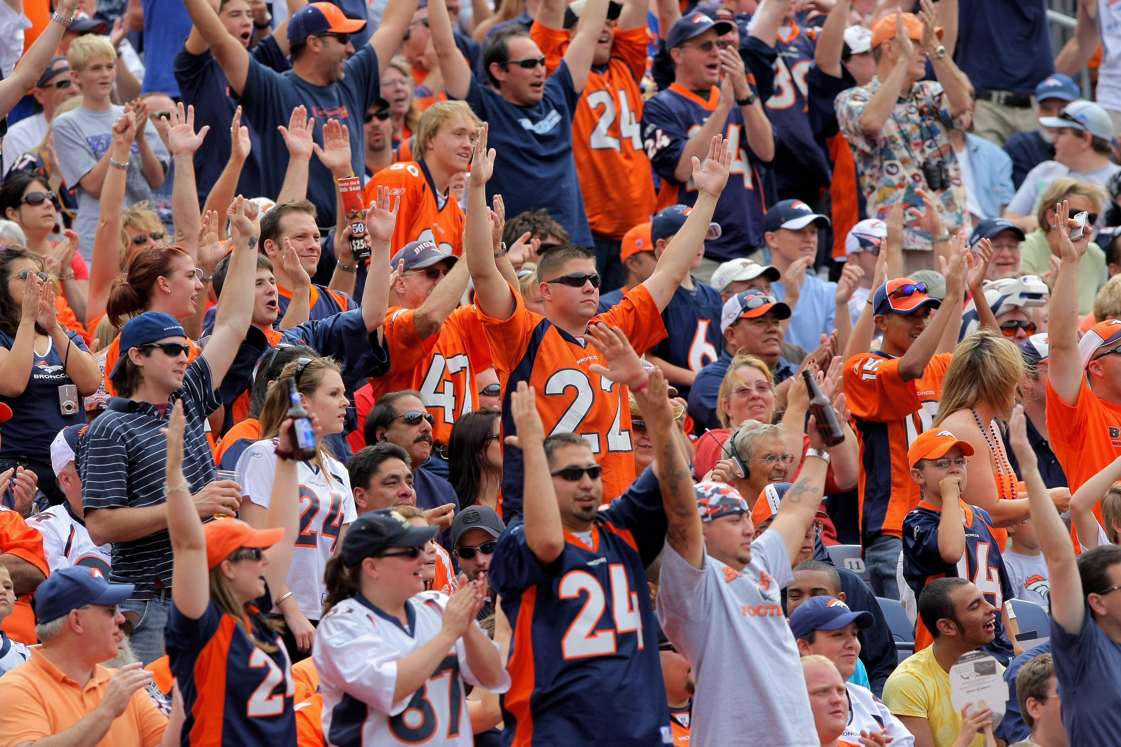 DENVER - SEPTEMBER 20:  Fans of the Denver Broncos cheer a touchdown against the Cleveland Browns during NFL action at Invesco Field at Mile High on September 20, 2009 in Denver, Colorado. The Broncos defeated the Browns 27-6.  (Photo by Doug Pensinger/Ge