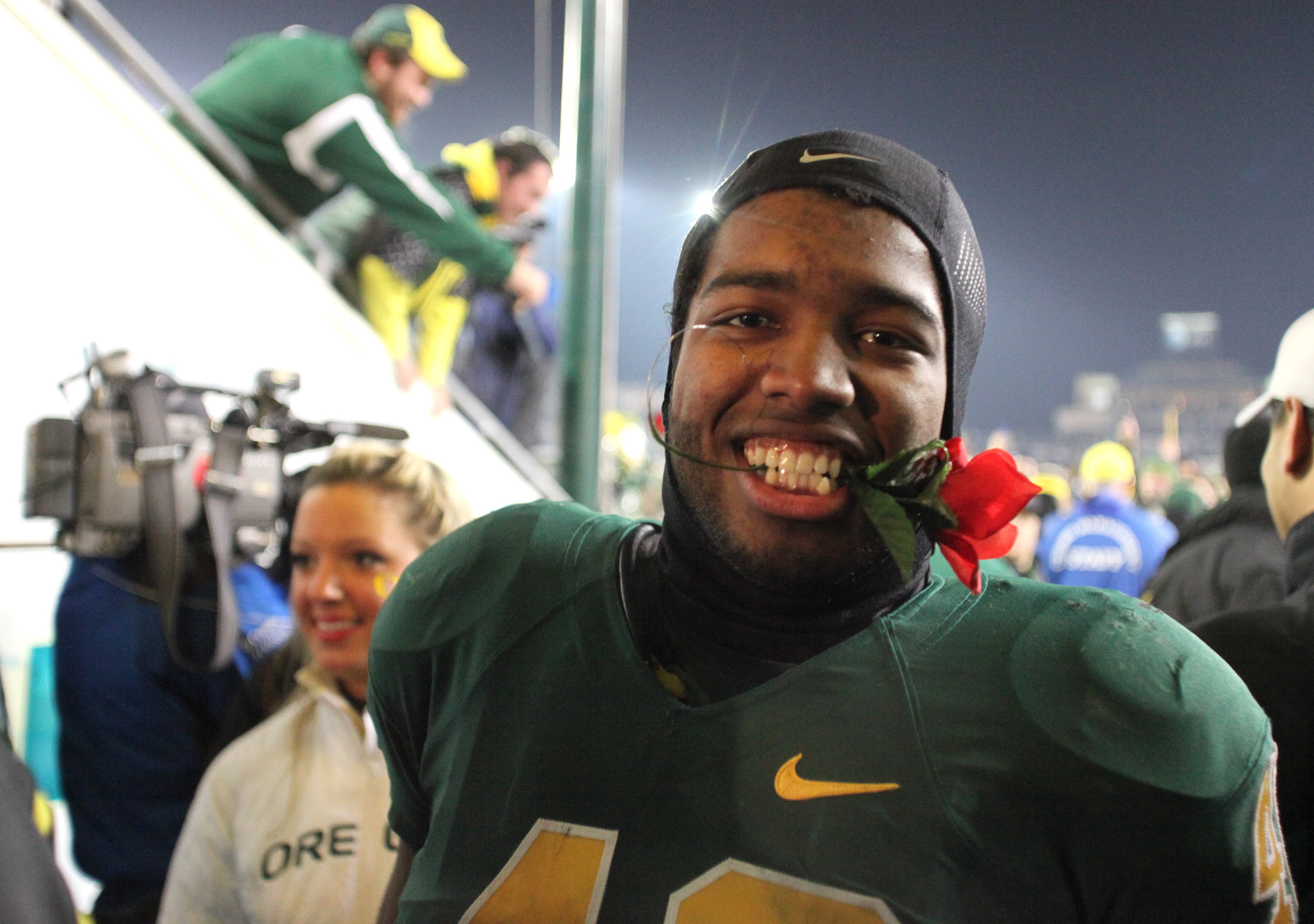 EUGENE, OR - DECEMBER 3:  Bryson Littlejohn #43 of the Oregon Ducks celebrates their Civil War victory over Oregon State holding a rose in his teeth at Autzen Stadium on December 3, 2009 in Eugene, Oregon. The Ducks defeated the Beavers 37-33. (Photo by T