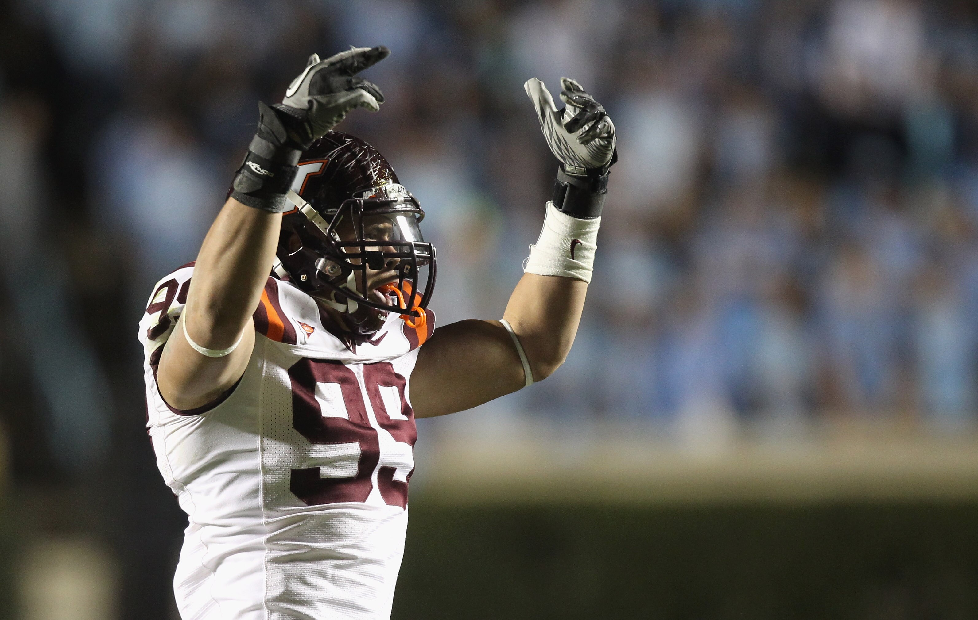CHAPEL HILL, NC - NOVEMBER 13:  James Gayle #99 of the Virginia Tech Hokies celebrates after a sack against the North Carolina Tar Heels during their game at Kenan Stadium on November 13, 2010 in Chapel Hill, North Carolina.  (Photo by Streeter Lecka/Gett