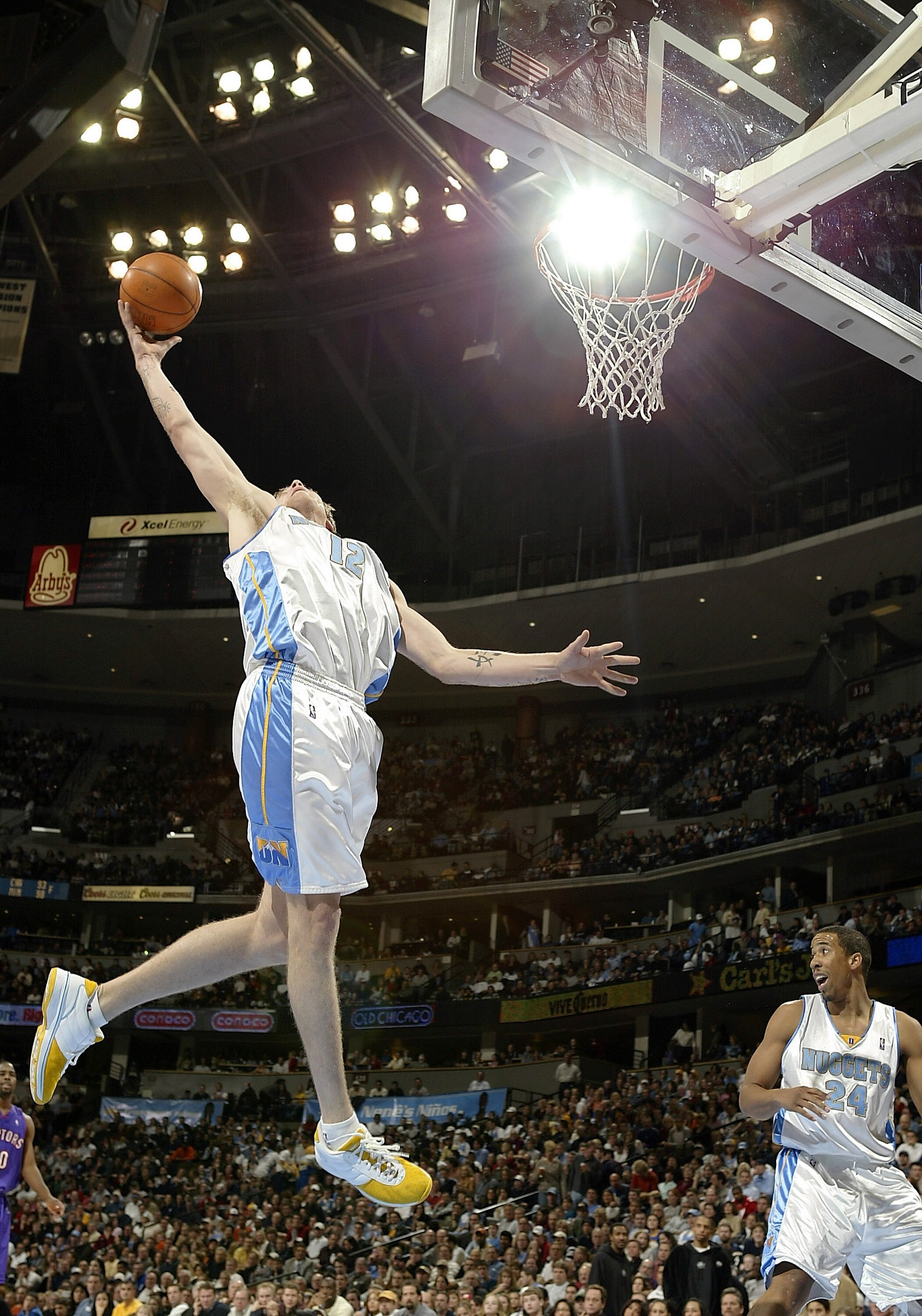 DENVER - DECEMBER 30:  Chris 'Birdman' Andersen#12 of the Denver Nuggets gets a defensive rebound against the Toronto Raptors in the second half of the game December 30, 2003 at the Pepsi Center in Denver, Colorado. The Raptors won 81-74.  NOTE TO USER: