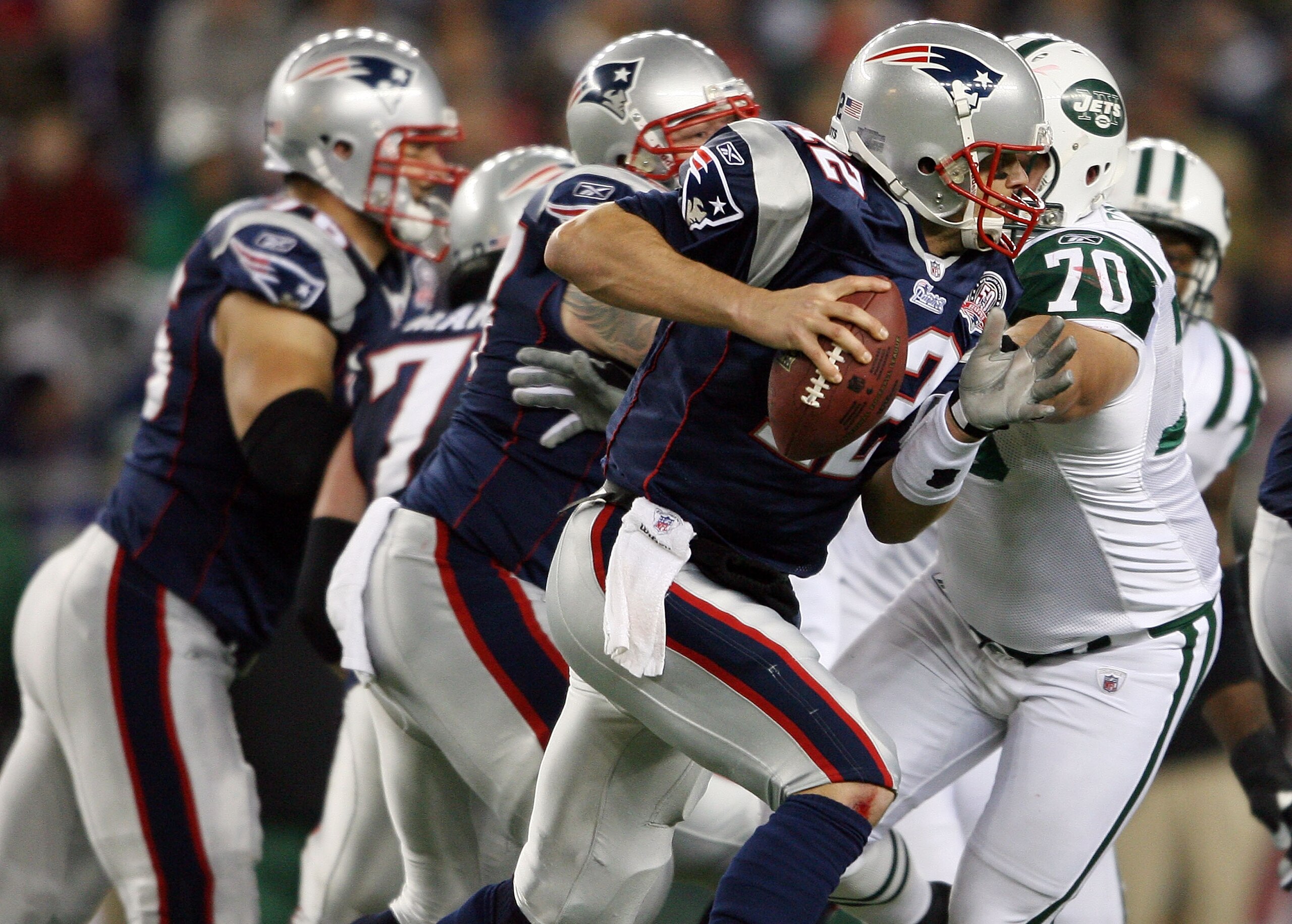 FOXBORO, MA - NOVEMBER 22: Tom Brady #12 of the New England Patriots scrambles as Mike DeVito #70 of the New York Jets pressures on November 22, 2009 at Gillette Stadium in Foxboro, Massachusetts. The Patriots defeated the Jets 31-14. (Photo by Elsa/Get FOXBORO, MA - NOVEMBER 22: Tom Brady #12 of the New England Patriots scrambles as Mike DeVito #70 of the New York Jets pressures on November 22, 2009 at Gillette Stadium in Foxboro, Massachusetts. The Patriots defeated the Jets 31-14. (Photo by Elsa/Get