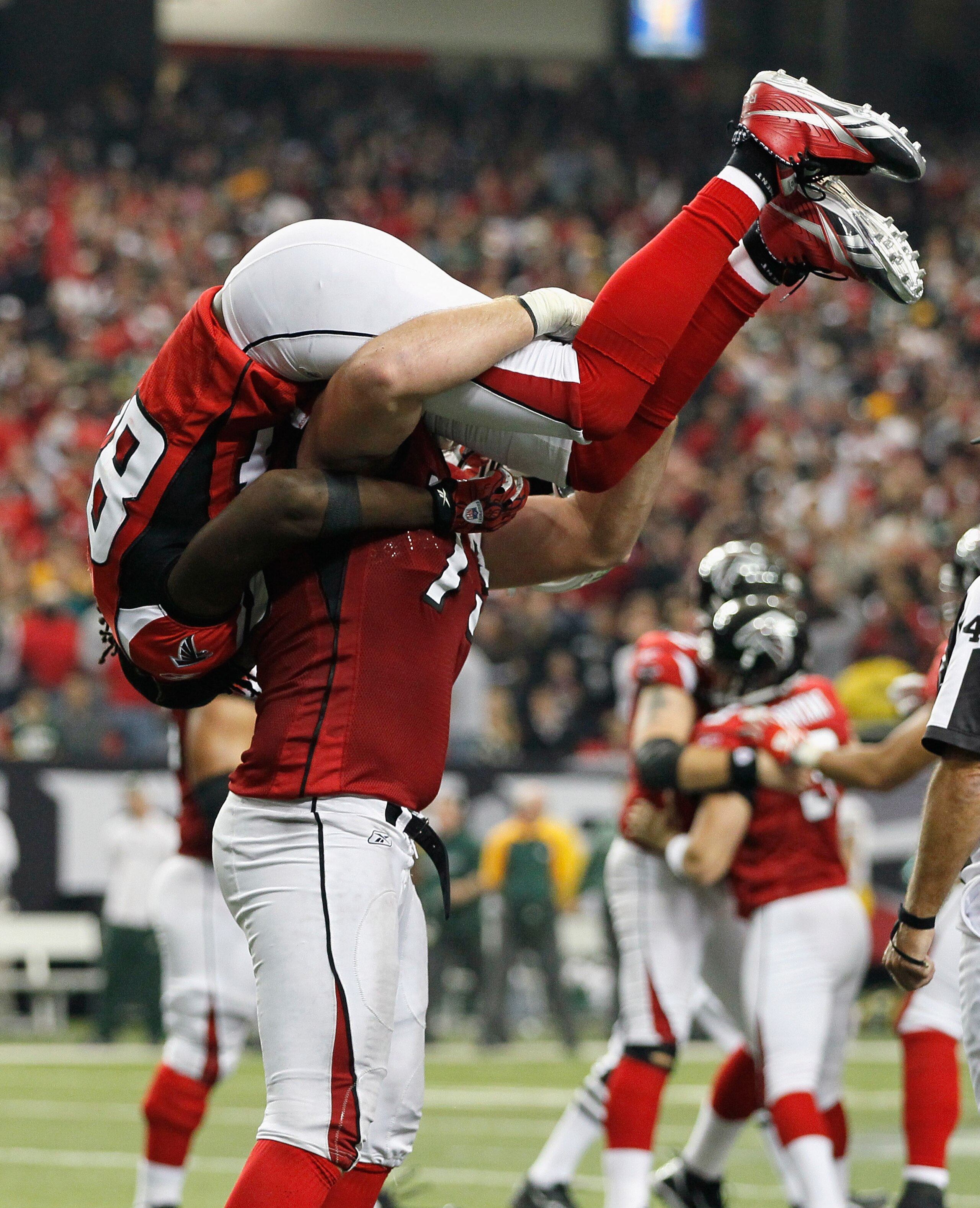 ATLANTA - NOVEMBER 28: Harvey Dahl #73 of the Atlanta Falcons lifts Roddy White #84 over his head in reaction to Matt Bryant's go-ahead field goal in the final seconds against the Green Bay Packers at Georgia Dome on November 28, 2010 in Atlanta, Georgia ATLANTA - NOVEMBER 28: Harvey Dahl #73 of the Atlanta Falcons lifts Roddy White #84 over his head in reaction to Matt Bryant's go-ahead field goal in the final seconds against the Green Bay Packers at Georgia Dome on November 28, 2010 in Atlanta, Georgia
