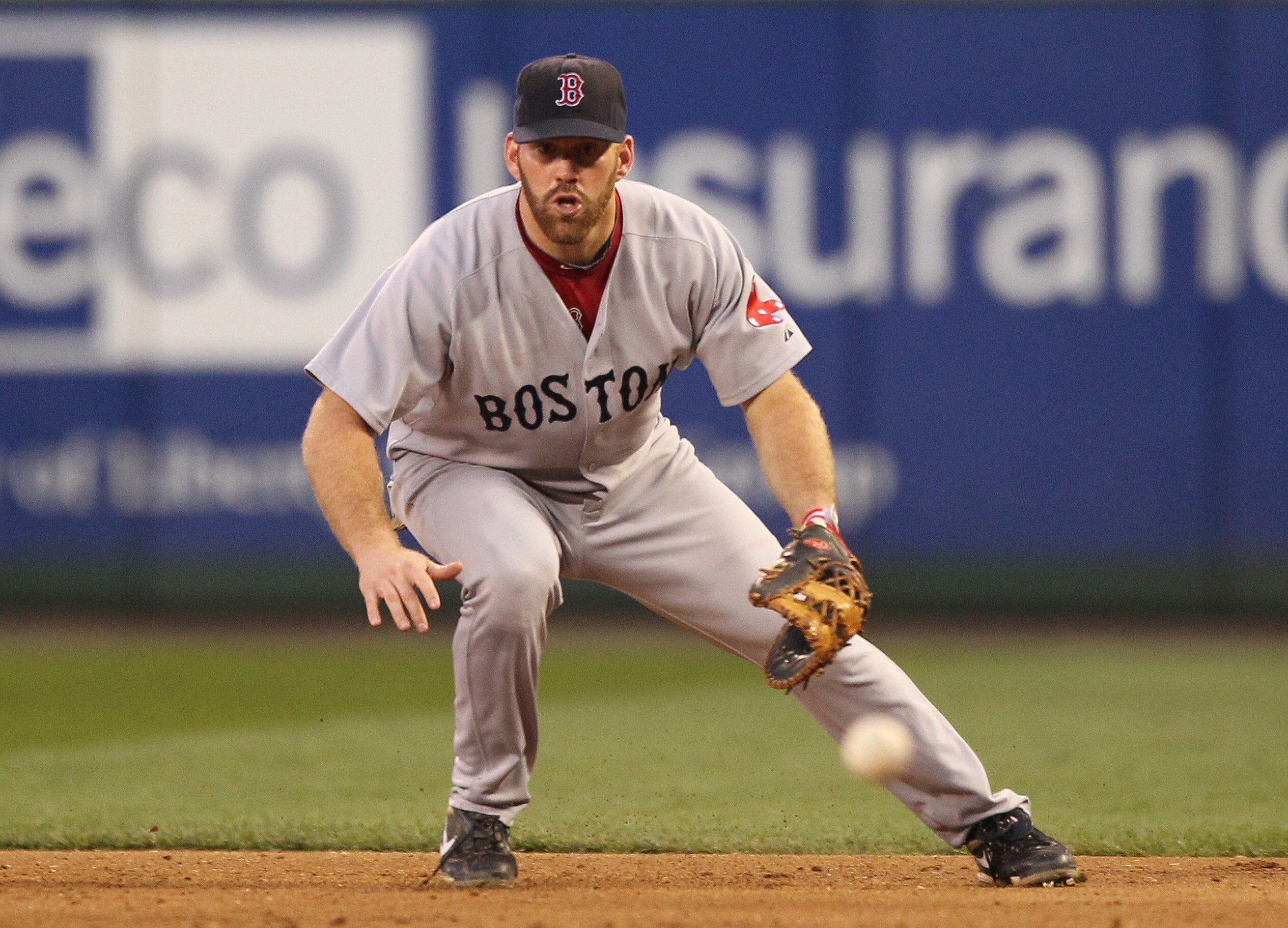 SEATTLE - JULY 23: Kevin Youkilis #20 of the Boston Red Sox fields a ground ball by Milton Bradley of the Seattle Mariners at Safeco Field on July 23, 2010 in Seattle, Washington. (Photo by Otto Greule Jr/Getty Images)