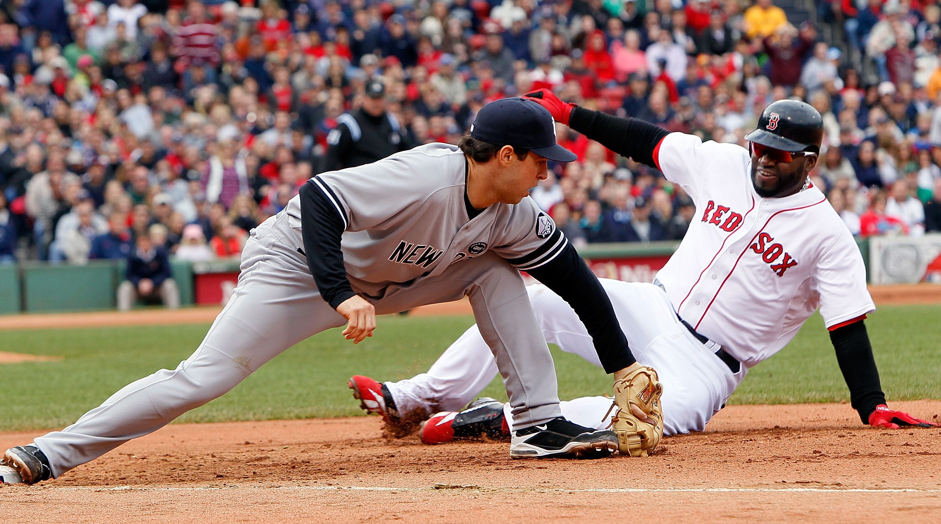 BOSTON - OCTOBER 3:  Mark Teixeira #25 of the New York Yankees executes the second out of a double play on base runner David Ortiz #34 of  the Boston Red Sox, who was caught off of first base, at Fenway Park, October 3, 2010, in Boston, Massachusetts. (Ph